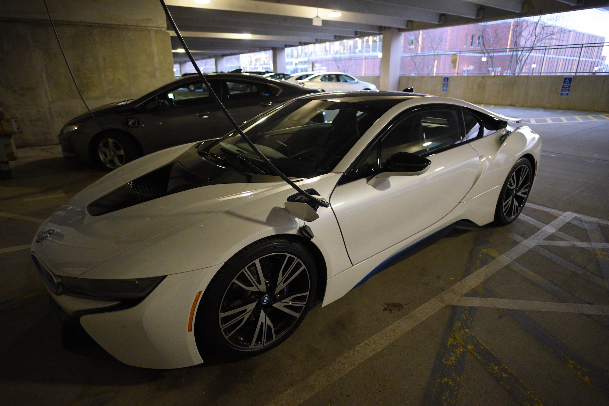 A BMW i8 parks at South garage and get charged by the on-campus charge station. New report finds $51.6 million in Volkswagen Settlement Funds headed to Connecticut could help accelerate all-electric transportation revolution. (Zhelun Lang/The Daily Campus)