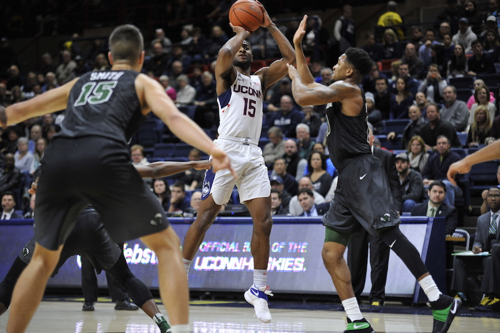 Rodney Purvis squares up for a shot while being defended by two Tulane players in Saturday's victory at Gampel Pavilion. (Jason Jiang/The Daily Campus)