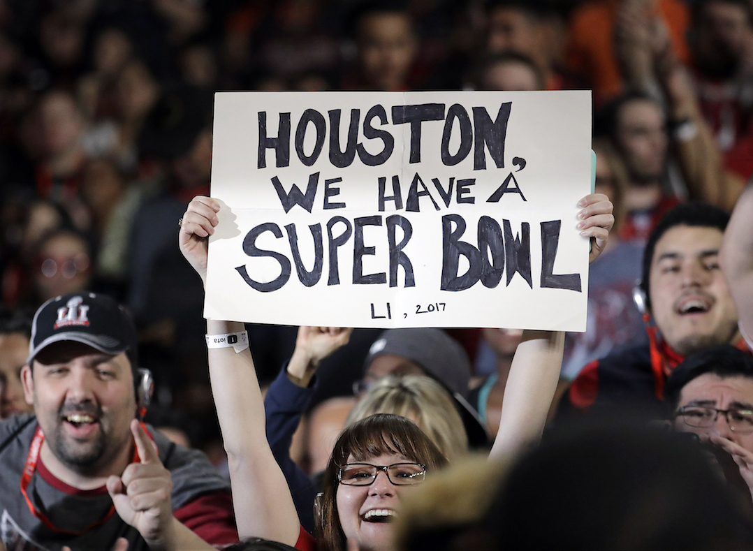 A fan holds a sign during opening night for the NFL Super Bowl 51 football game between the New England Patriots and the Atlanta Falcons at Minute Maid Park Monday, Jan. 30, 2017, in Houston. (AP Photo/Charlie Riedel)