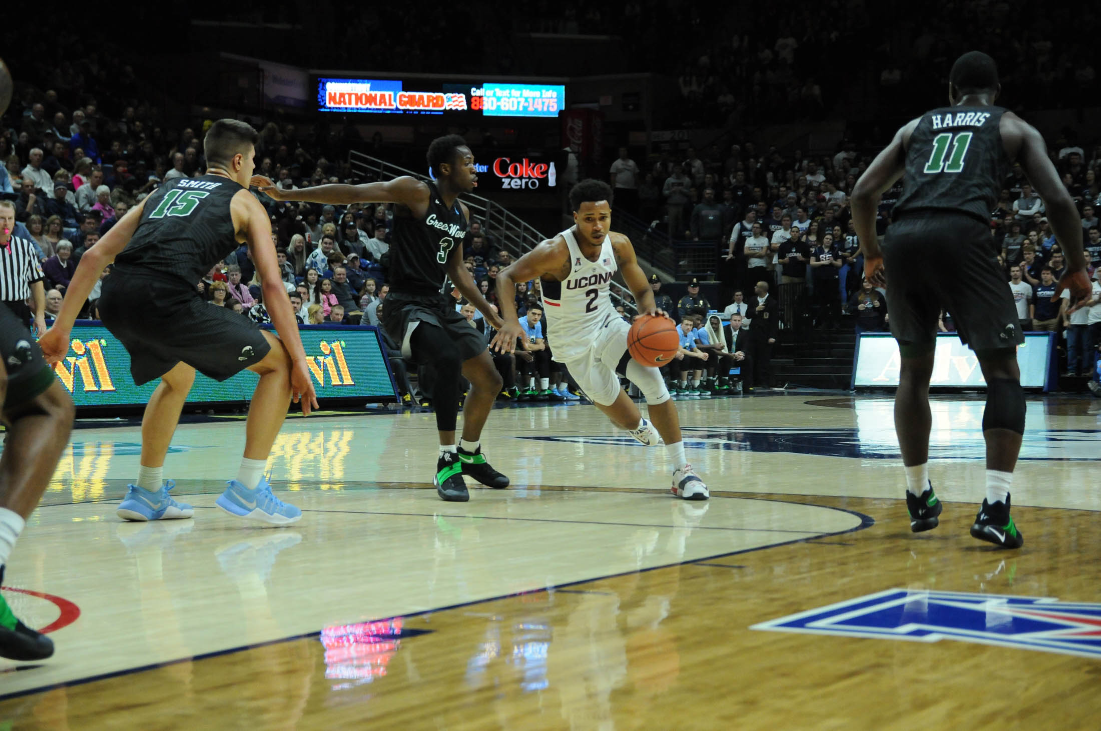 Sophomore guard Jalen Adams avoids a Tulane defender during the Huskies 78-68 victory over the Green Wave Saturday. Jan. 28, 2016 in Gampel Pavilion. (Olivia Stenger/The Daily Campus)