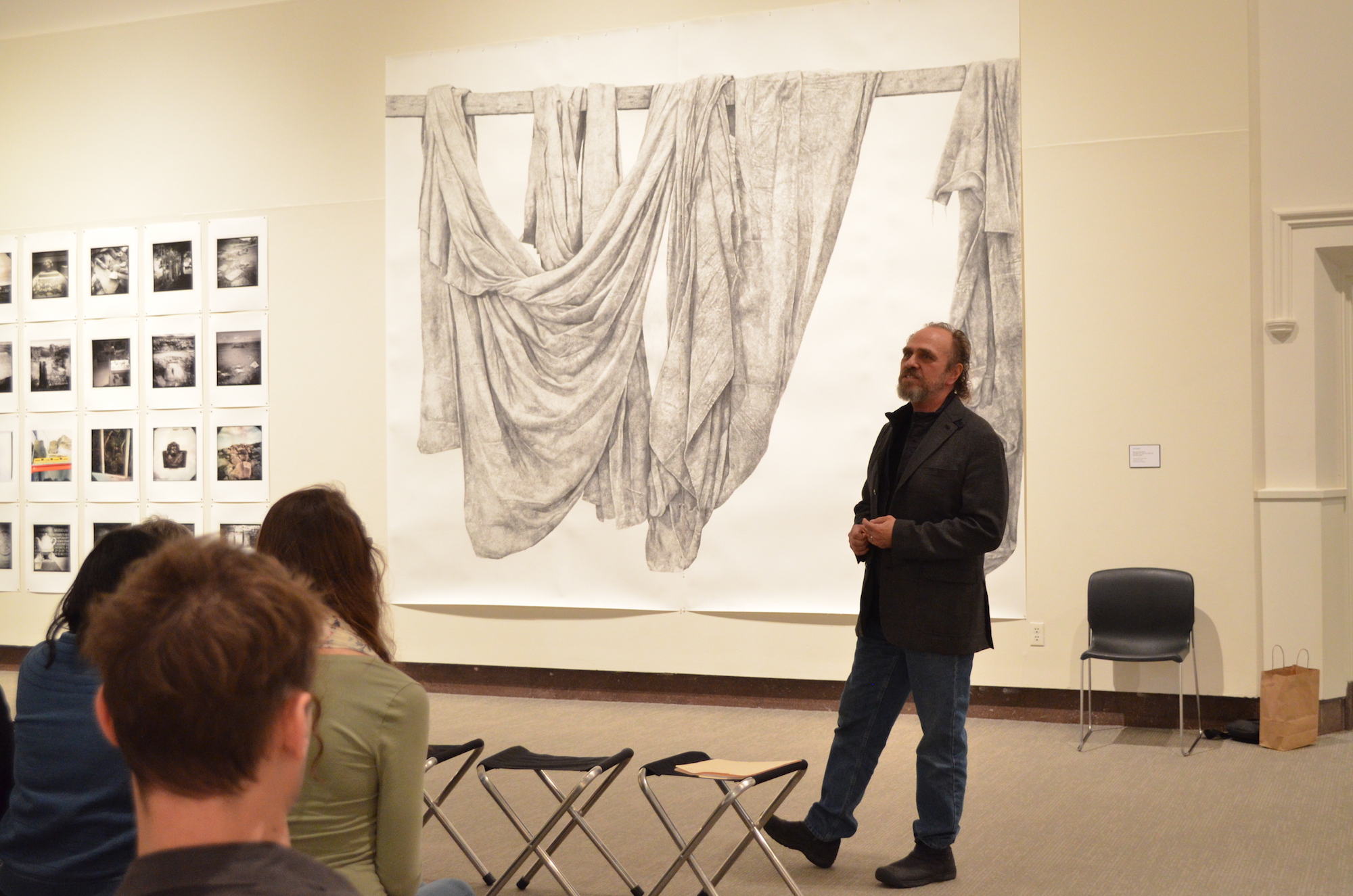 UConn Associate Professor of Sculpture and Drawing Ray DiCapura presents a background of one of his pieces and answers questions from the audience at the Benton on Wednesday, February 8. DiCapura is a two-time McDowell Colony resident and has exhibited his works at the Smithsonian in Washington, DC. (Akshara Thejawsi/The Daily Campus)