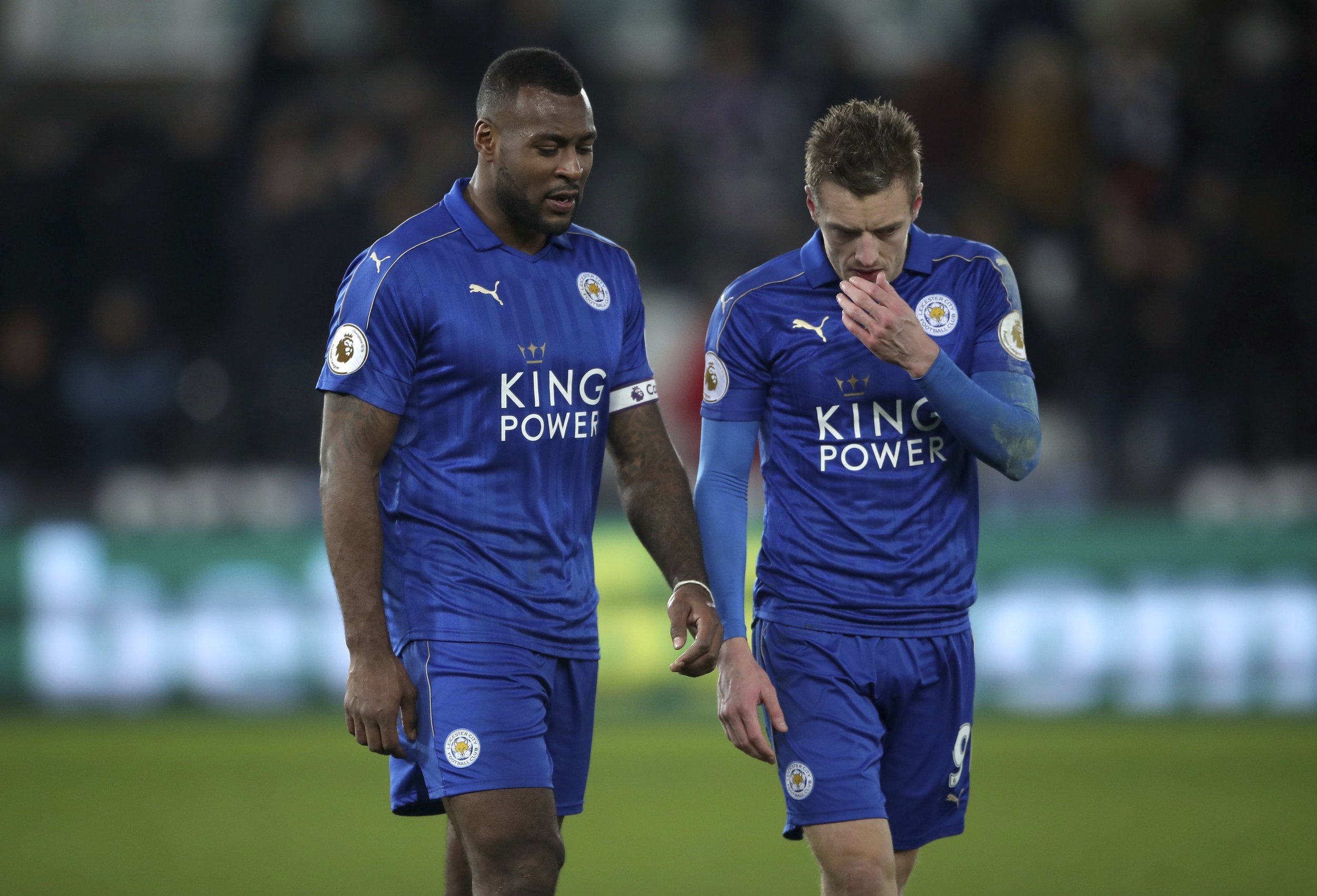 Leicester City's Wes Morgan, left, and Jamie Vardy leave the pitch after the English Premier League match Swansea against Leicester at the Liberty Stadium, Swansea, Wales, Sunday Feb. 12, 2017. (Nick Potts/PA via AP)