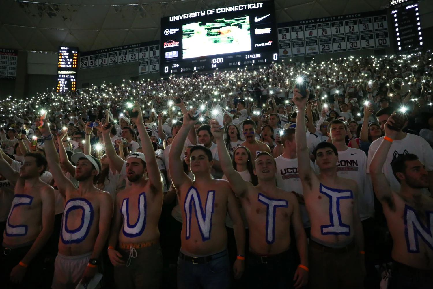 Students hold their cell phone flashlights for the national anthem. (Jackson Haigis/The Daily Campus)