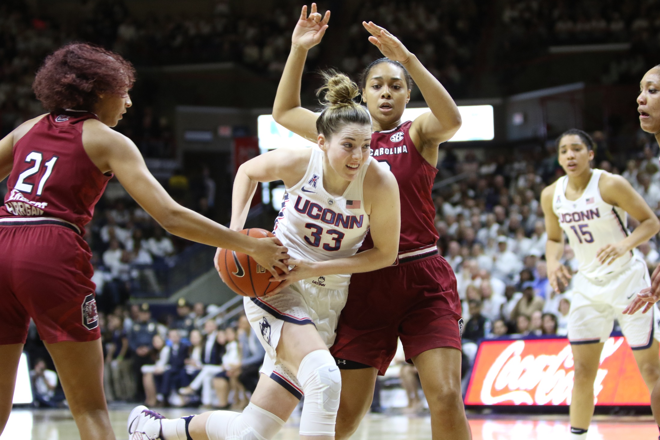 Katie Lou Samuelson attempts to evade two USC defenders in the first half of Monday night's game at Gampel Pavilion. (Jackson Haigis/The Daily Campus)