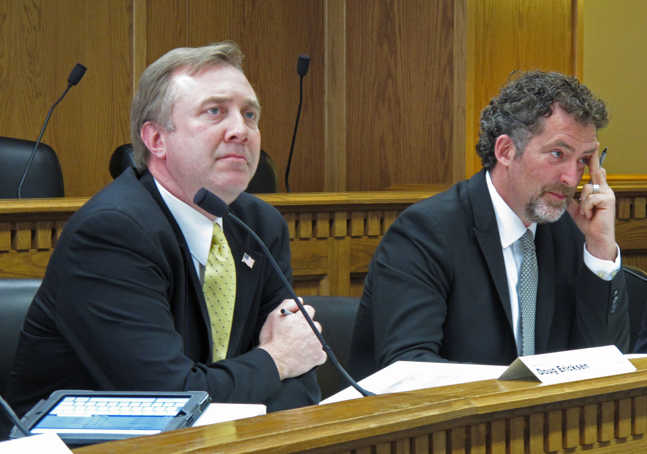 In this March 26, 2013 file photo, Republican state Sen. Doug Ericksen, left, and Democratic state Sen. Kevin Ranker listen to testimony from a climate change skeptic at a hearing in Olympia, Wash. Environmentalists are bracing for court battles over what they fear will be an unprecedented wave of rollbacks on policies concerning climate change. (Rachel La Corte/AP)