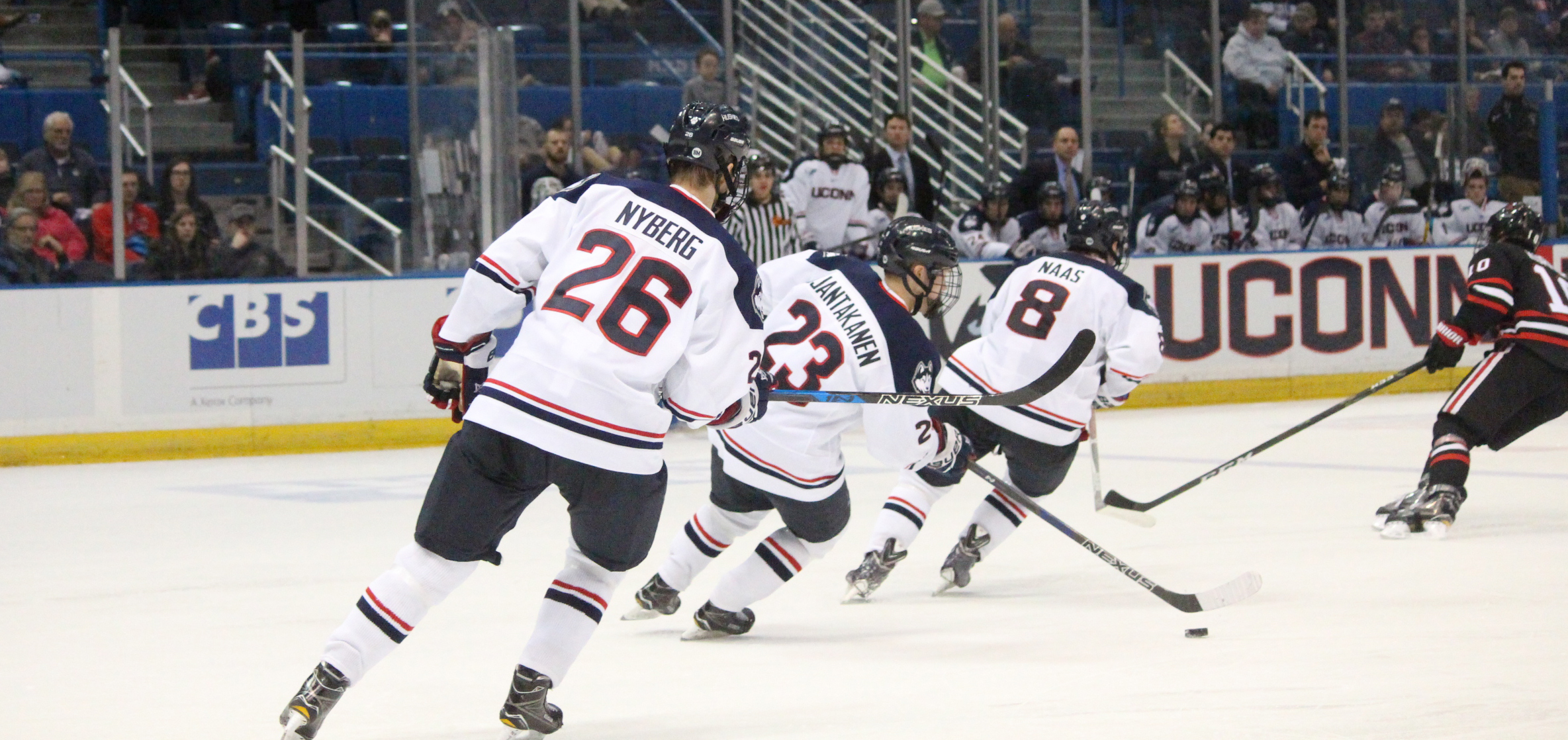 Philip Nyberg (#26), Kasperi Ojantakanen (#23) and Spencer Naas (#8) take the puck up in UConn's loss to Northeastern on Friday night at the XL Center. (Mustafe Mussa/The Daily Campus)