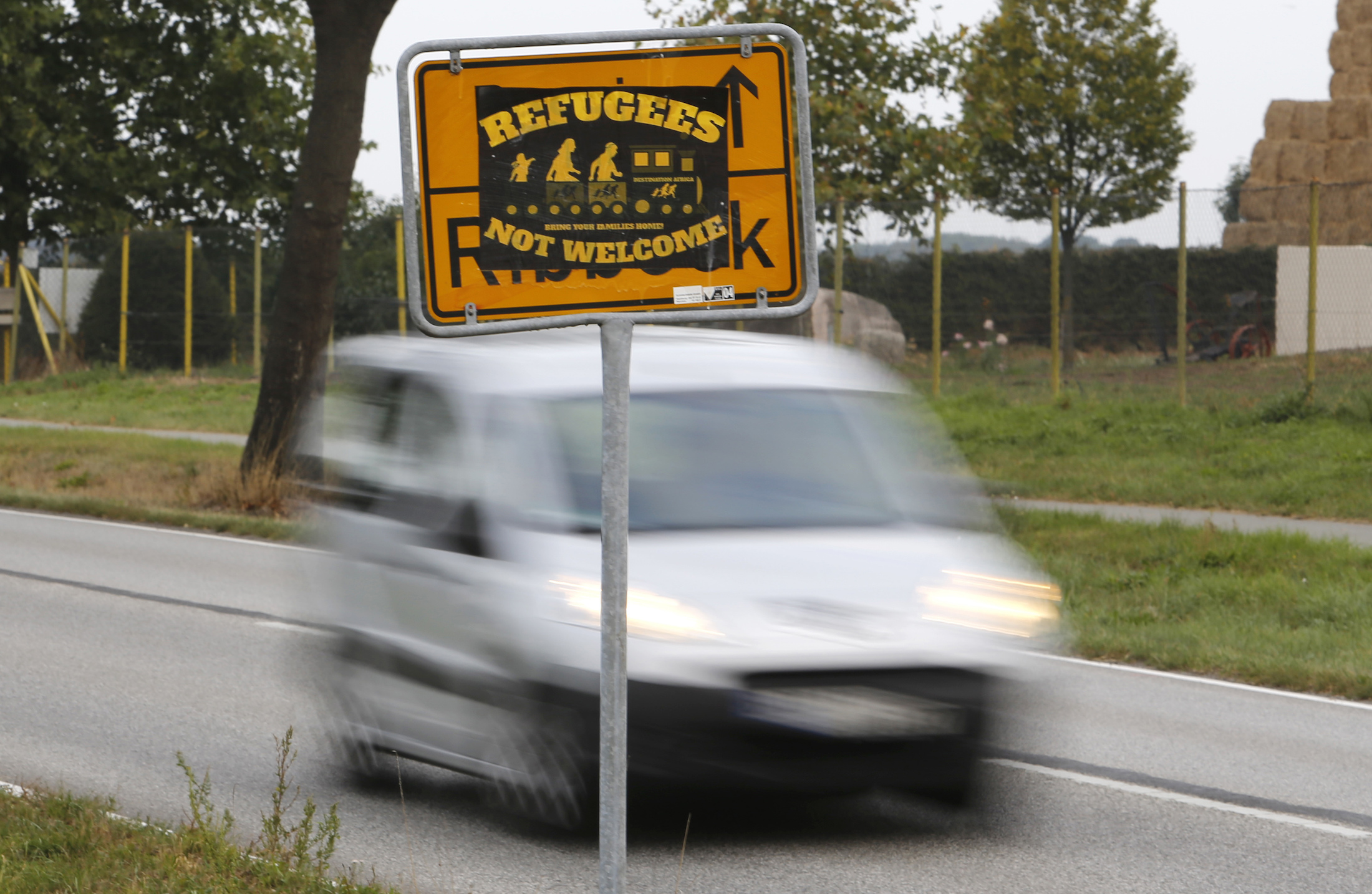 The Sept. 23, 2016 shows a poster 'Refugees not welcome' sticked on a city sign in the outskirts of Nauen, eastern Germany, one of several thousand hate crimes in Germany in 2016. (Ferdinand Ostrop/AP)