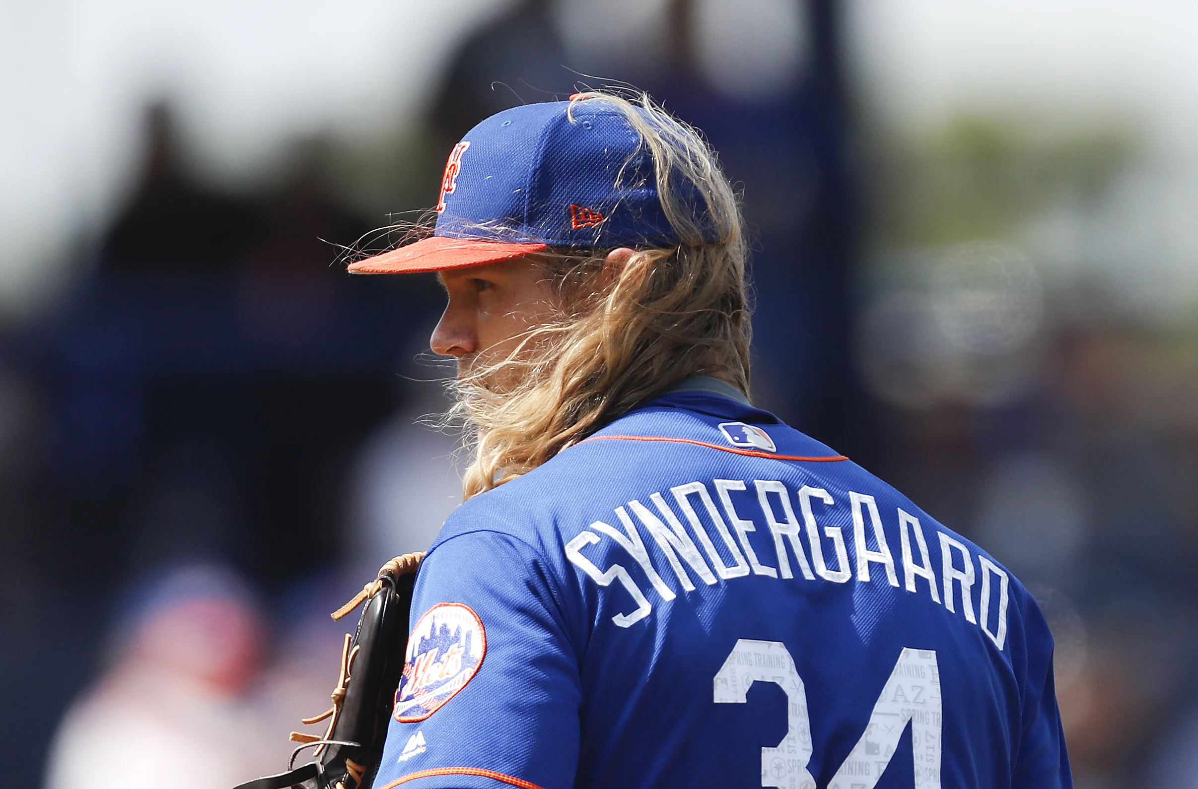 The wind blows New York Mets starting pitcher Noah Syndergaard's hair as he looks in for the sign from New York Mets catcher Rene Rivera in the second inning of a spring training baseball game against the Houston Astros, Friday, March 3, 2017, in Port St. Lucie, Fla. (AP Photo/John Bazemore)