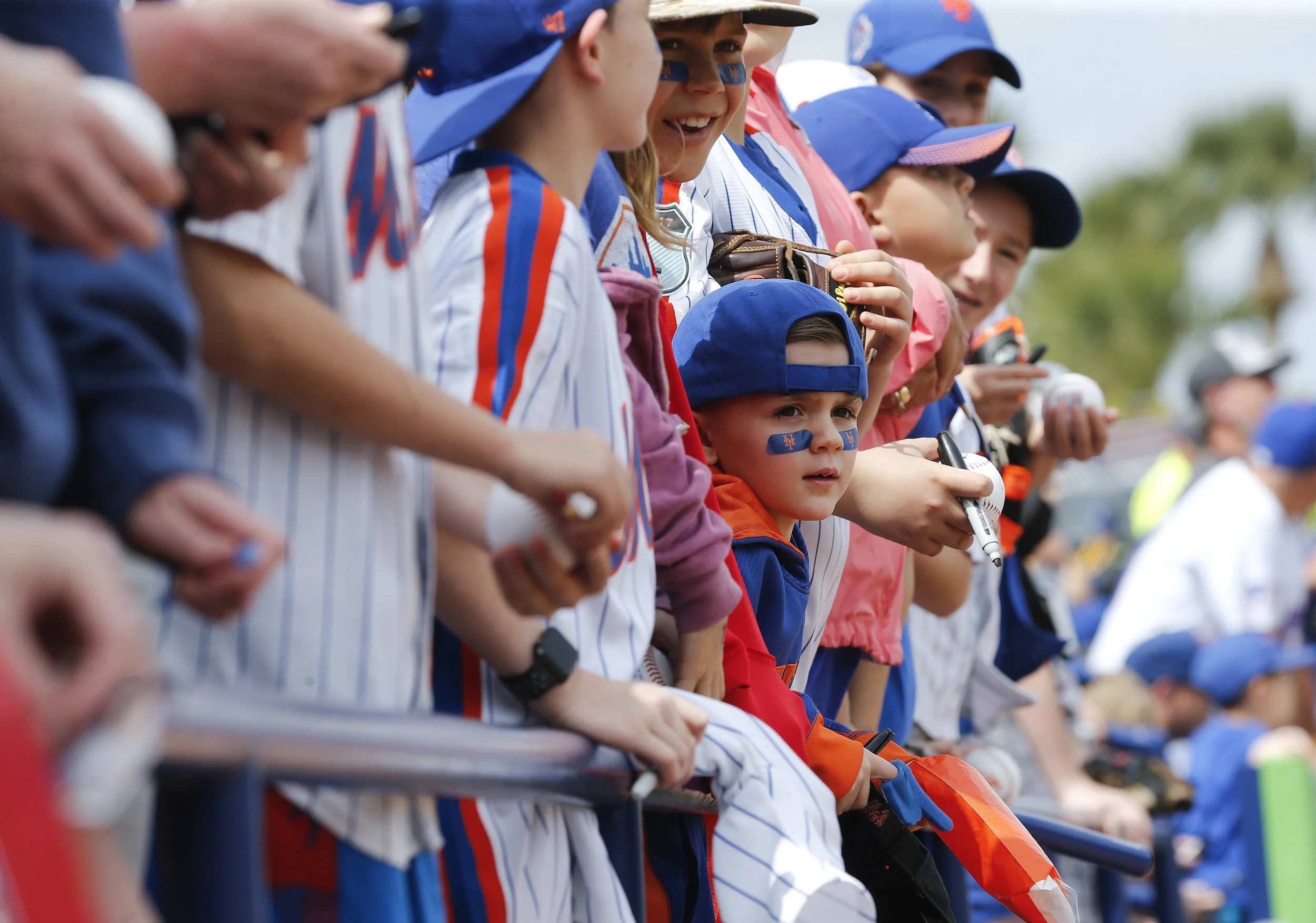 Young fans wait for autographs before a spring training baseball game between the New York Mets and the Houston Astros, Friday, March 3, 2017, in Port St. Lucie, Fla. (AP Photo/John Bazemore)