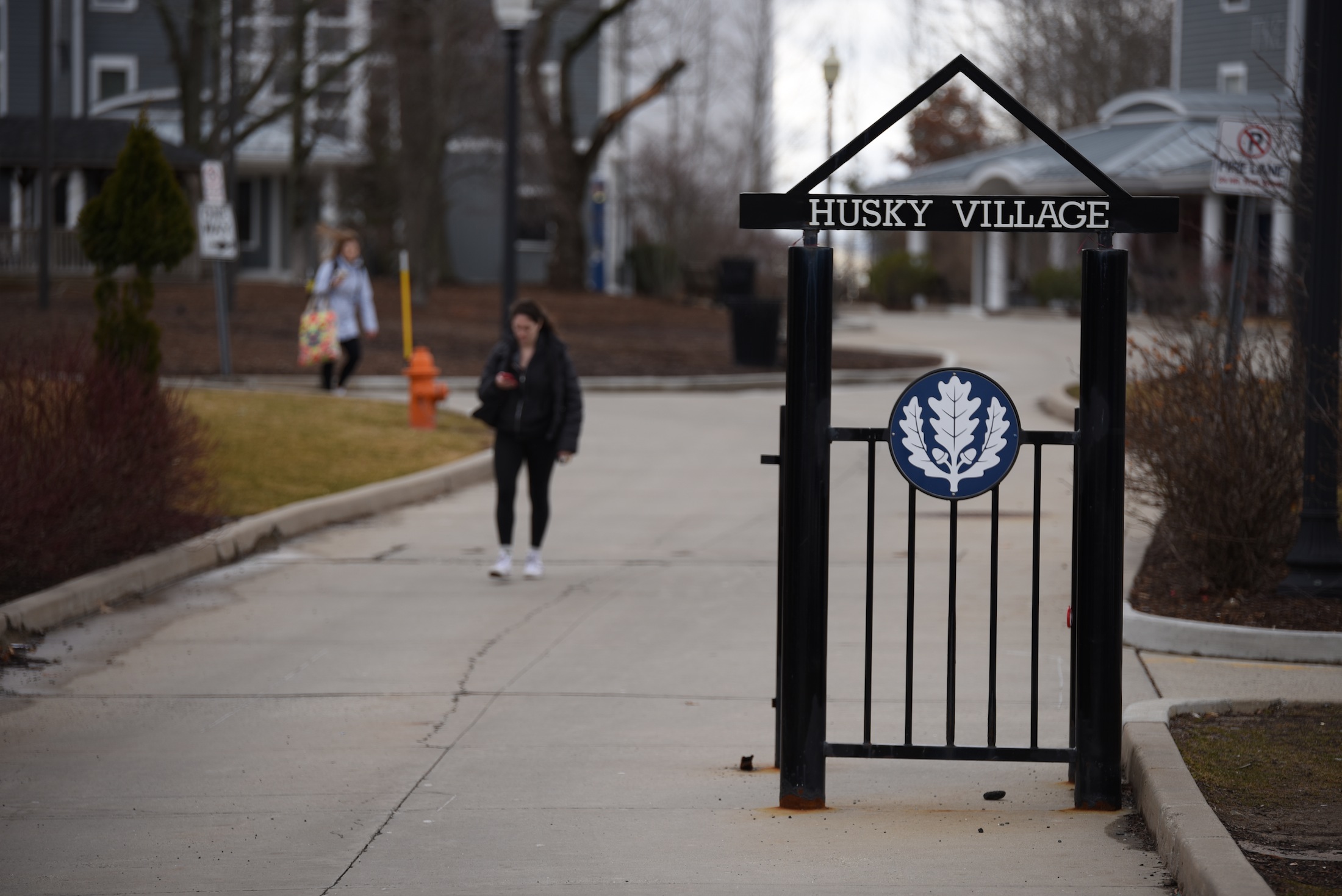 A student walks through Husky Village. (Zhelun Lang/The Daily Campus)