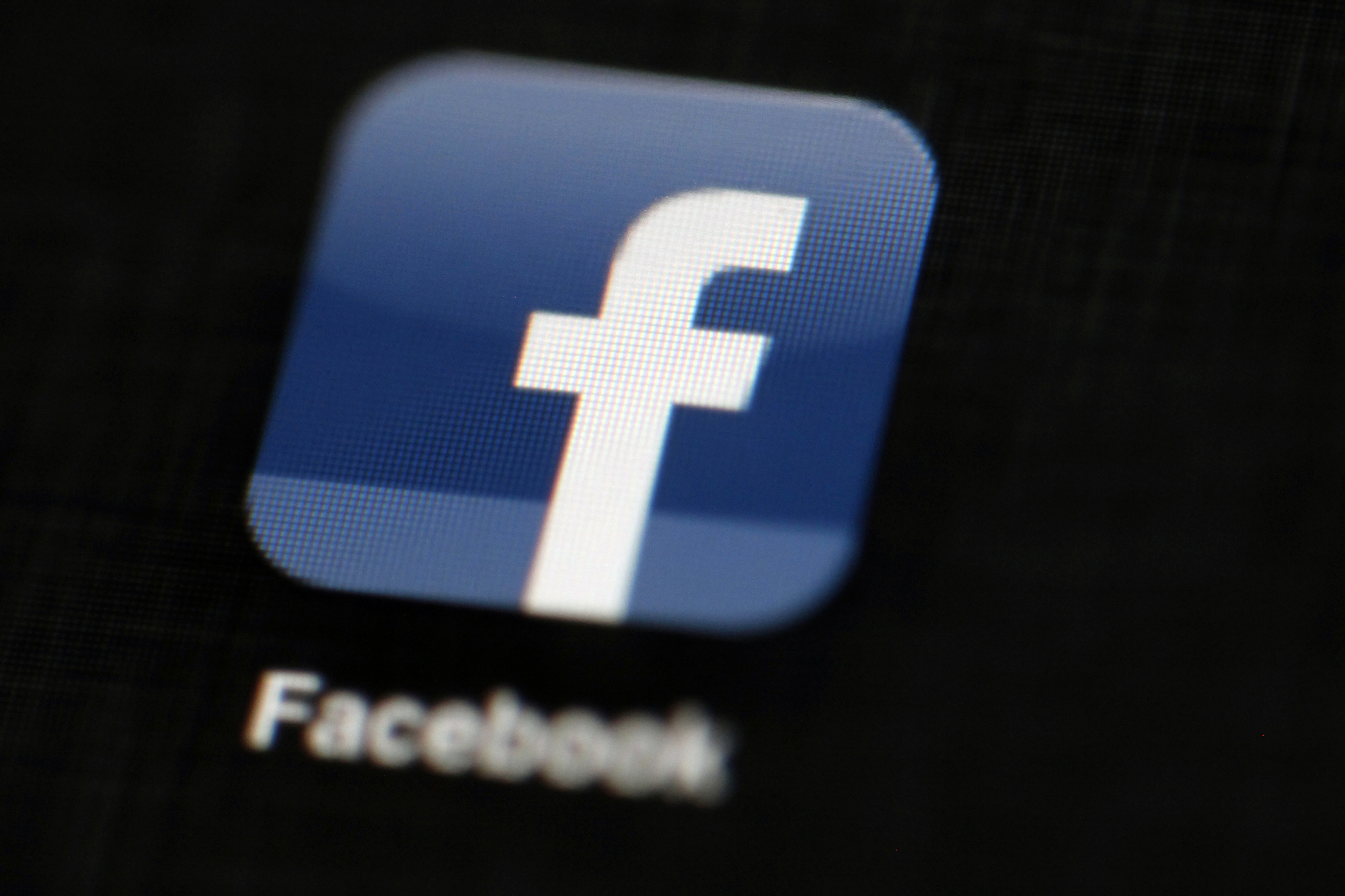 In this May 16, 2012, file photo, the Facebook logo is displayed on an iPad in Philadelphia. Recently, the government has attempted to sway social media companies to take down blasphemous content. (Matt Rourke/AP)