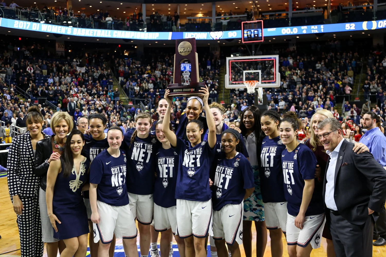 The Huskies pose for a photo with the Bridgeport Region trophy, held by senior Saniya Chong.