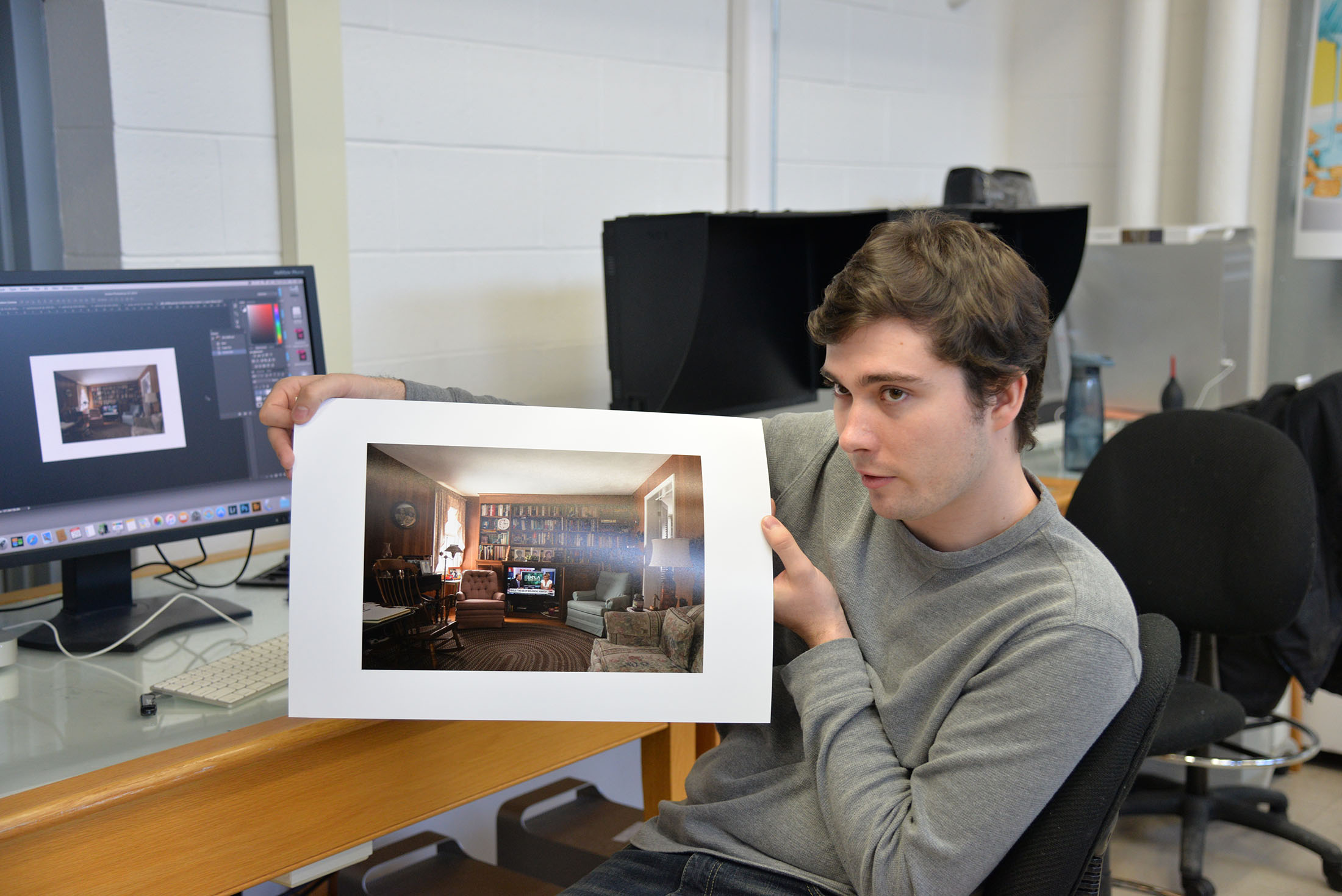 Michael Amato shows off the drafts of his work for the BFA show and talks about the theme of his work fear culture. (Amar Batra/The Daily Campus)
