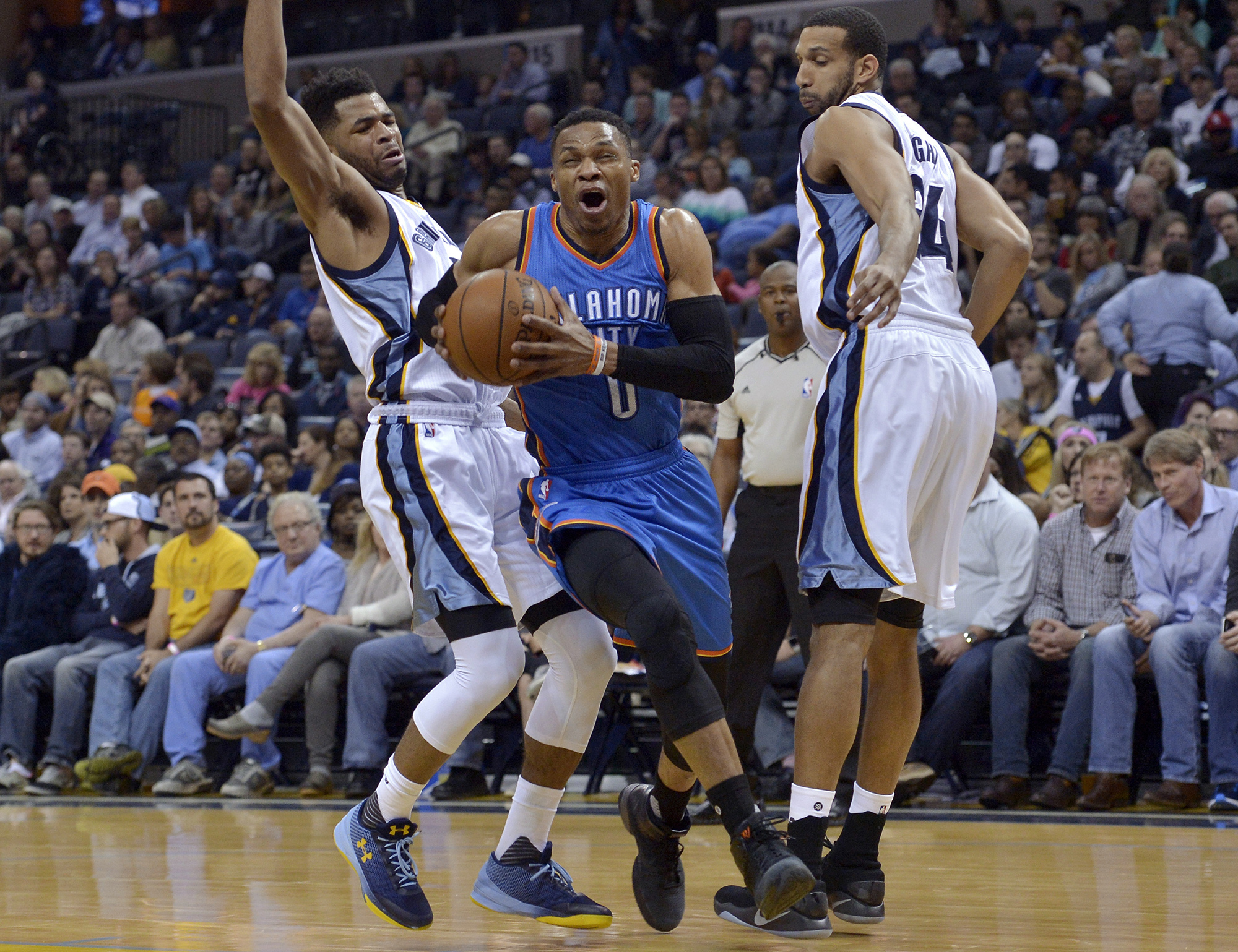 Oklahoma City Thunder guard Russell Westbrook (0) drives between Memphis Grizzlies guard Andrew Harrison, left, and forward Brandan Wright during the first half of an NBA basketball game Wednesday, April 5, 2017, in Memphis, Tenn. (Brandon Dill/AP)