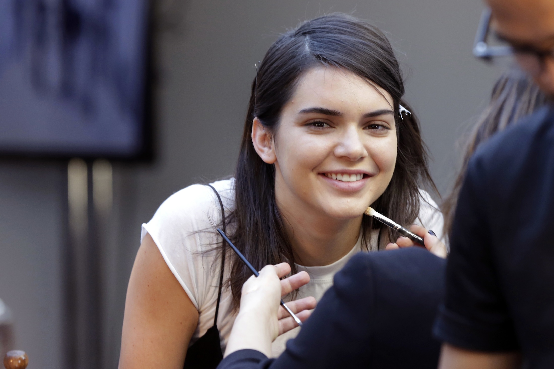 In this Wednesday, Sept. 14, 2016, file photo, model Kendall Jenner has makeup applied backstage before the Michael Kors Spring 2017 collection is modeled during Fashion Week, in New York. Pepsi is not saying whether it will continue to run an ad, featuring Jenner, that is being widely criticized and mocked on social media for appearing to trivialize protests for social justice causes. (Richard Drew/AP)