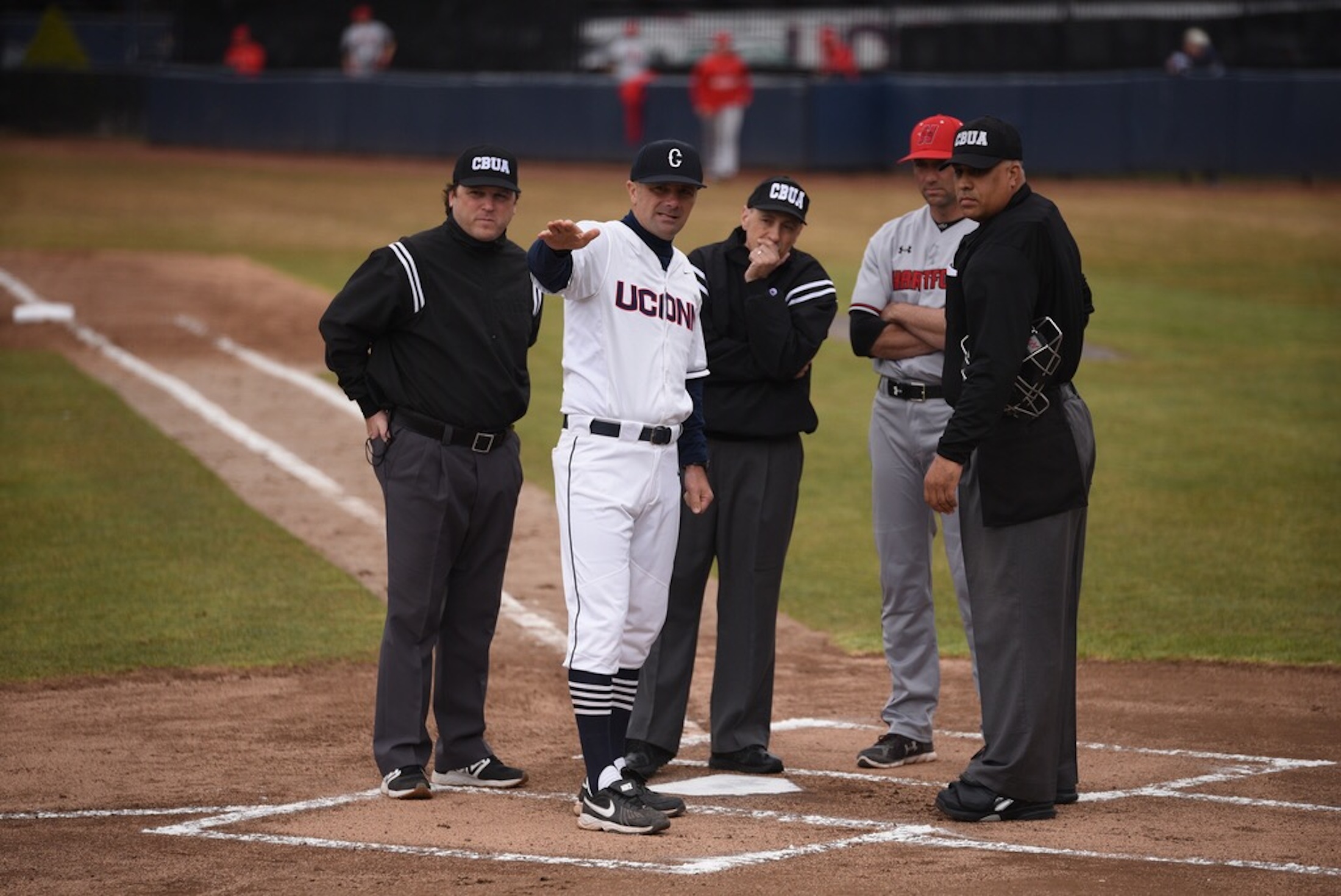 UConn manager Jim Penders converses with the umpires during the Huskies' gam against Hartford on April 5, 2017. (Zhleun Lang/The Daily Campus)