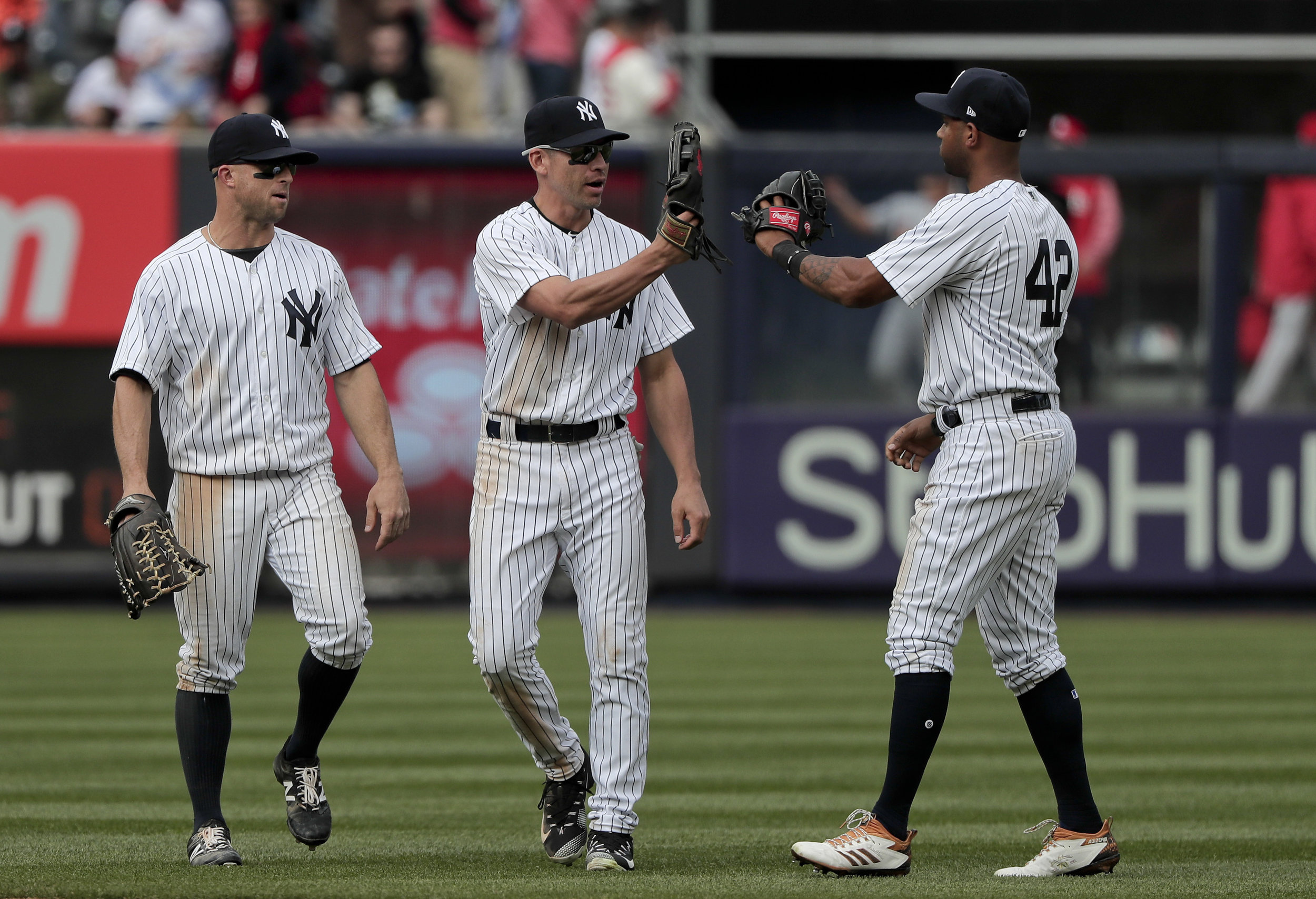 From left to right, New York Yankees Brett Gardner, Jacoby Ellsbury and Aaron Hicks celebrate after they defeated the St. Louis Cardinals in a baseball game, Saturday, April 15, 2017, in New York. (AP Photo/Julie Jacobson)