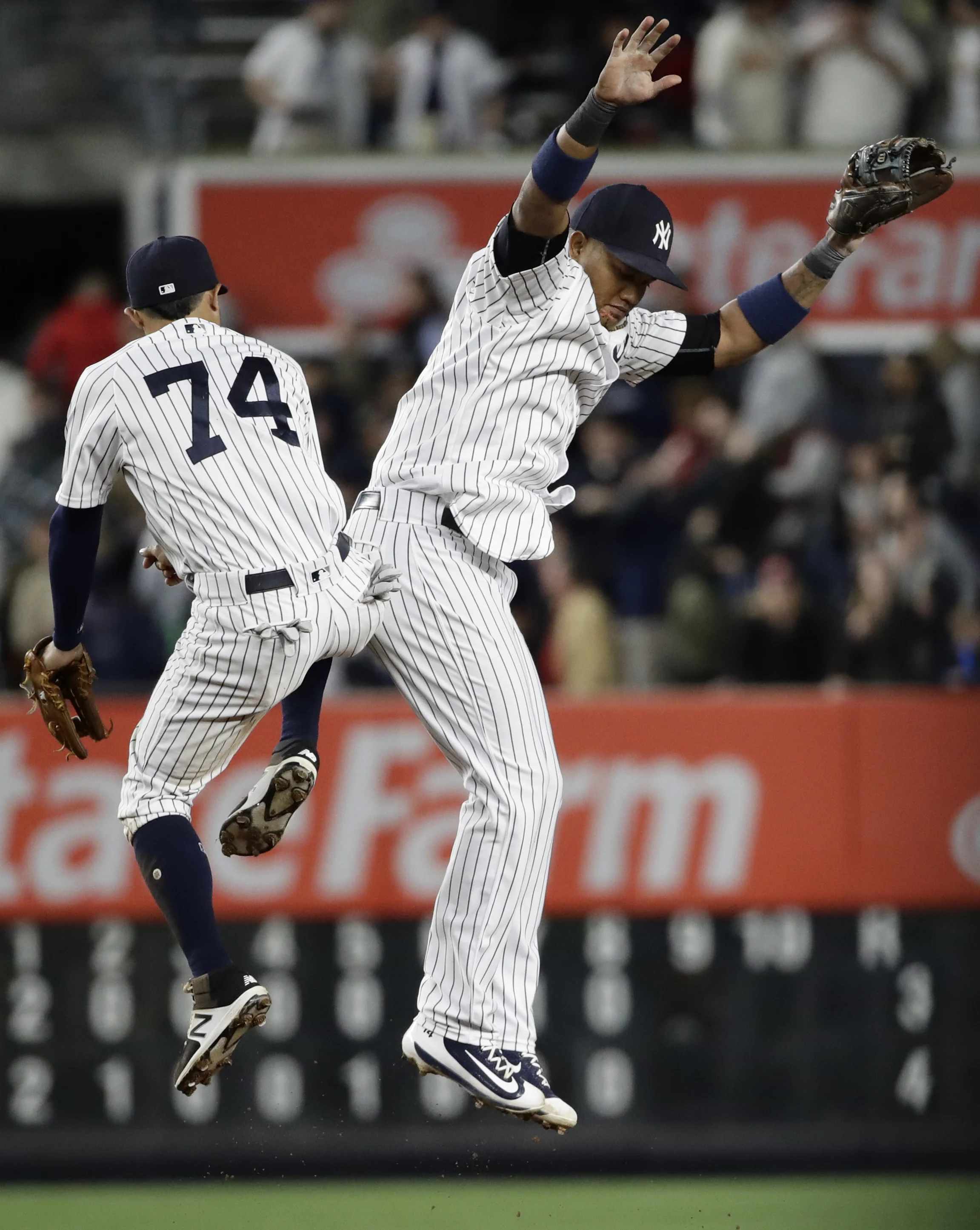New York Yankees' Starlin Castro, right, celebrates with Ronald Torreyes (74) after a baseball game against the St. Louis Cardinals, Friday, April 14, 2017, in New York. (AP Photo/Frank Franklin II)
