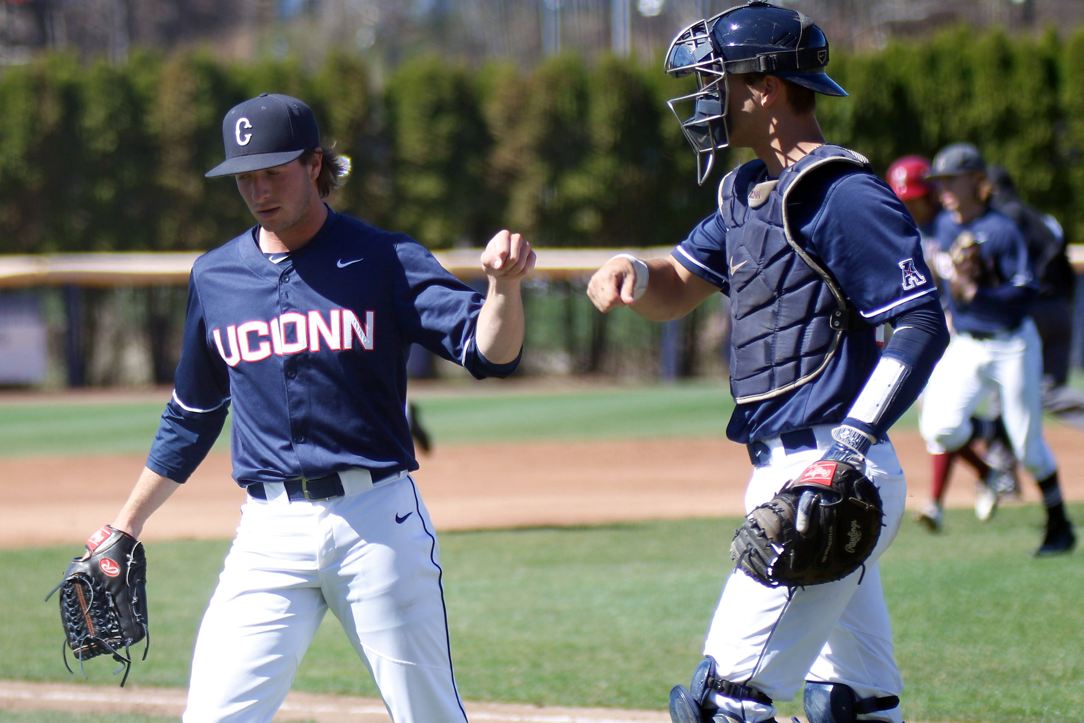 UConn pitcher P.J. Poulin bumps fists with his catcher during the Huskies 11-3 victory over UMass Amherst on Tuesday, April 18, 2017. (Ian Bethune/The UConn Blog)