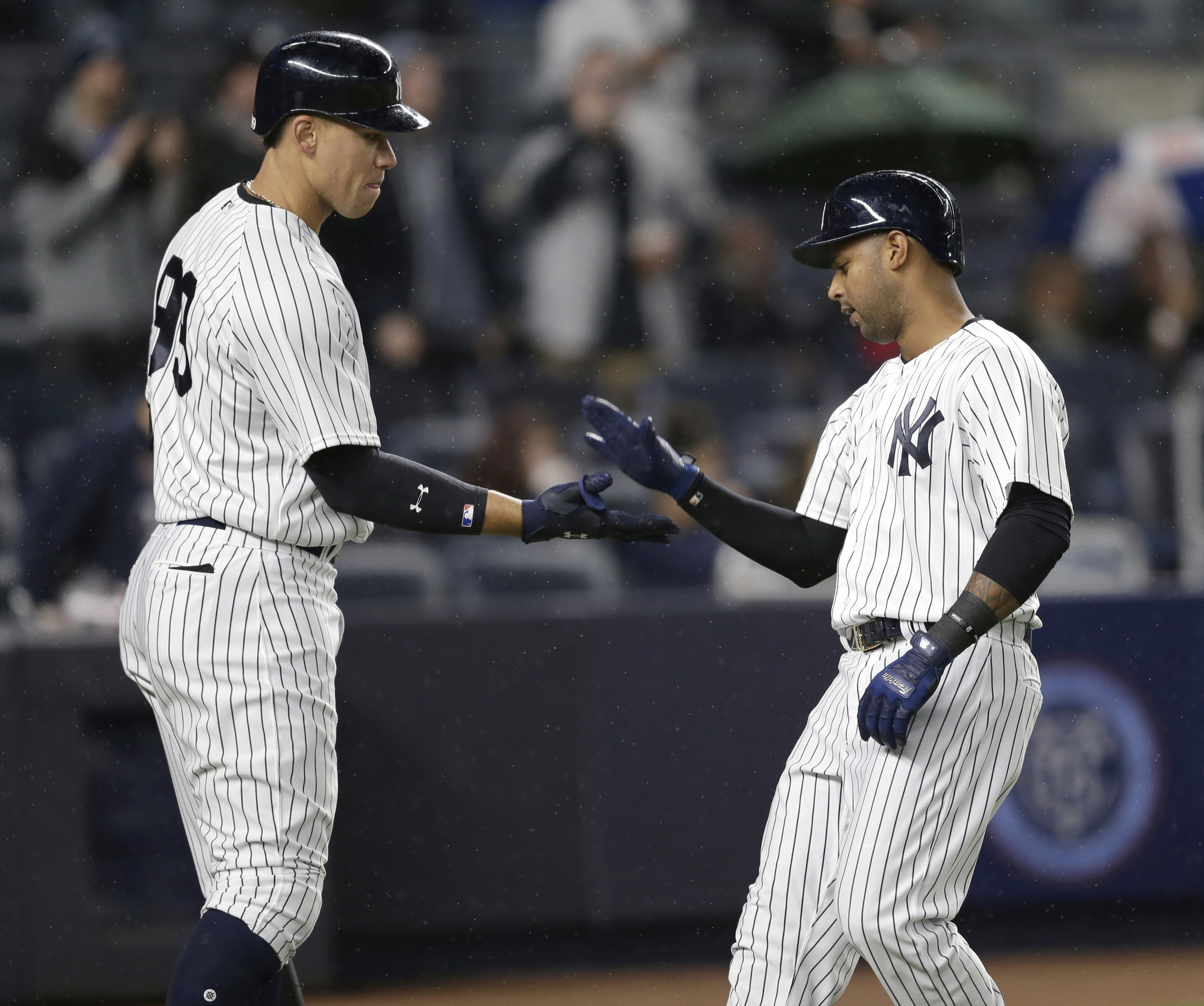 New York Yankees' Aaron Hicks, right, celebrates with Aaron Judge after hitting a solo home run during the eighth inning of the baseball game against the Chicago White Sox at Yankee Stadium, Wednesday, April 19, 2017, in New York. The Yankees defeated the White Sox 9-1. (Seth Wenig/AP)
