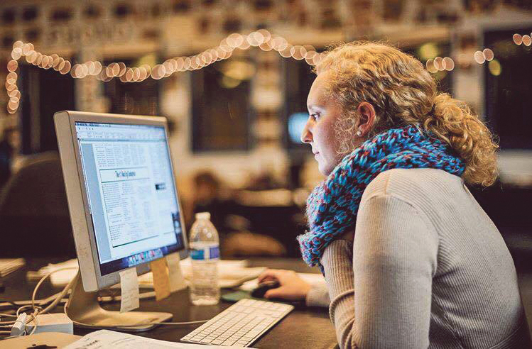 Bailey Wright checking pages during production at The Daily Campus. (Jason Jiang/The Daily Campus)