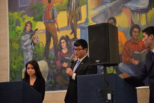 Savino (left) debates with other trustee candidates. (Amar Batra/The Daily Campus)