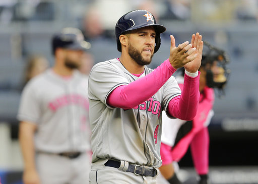 Houston Astros' George Springer applauds after scoring a run on a hit by Carlos Correa during the third inning of a baseball game against the New York Yankees, Sunday, May 14, 2017, in New York. (AP Photo/Seth Wenig)