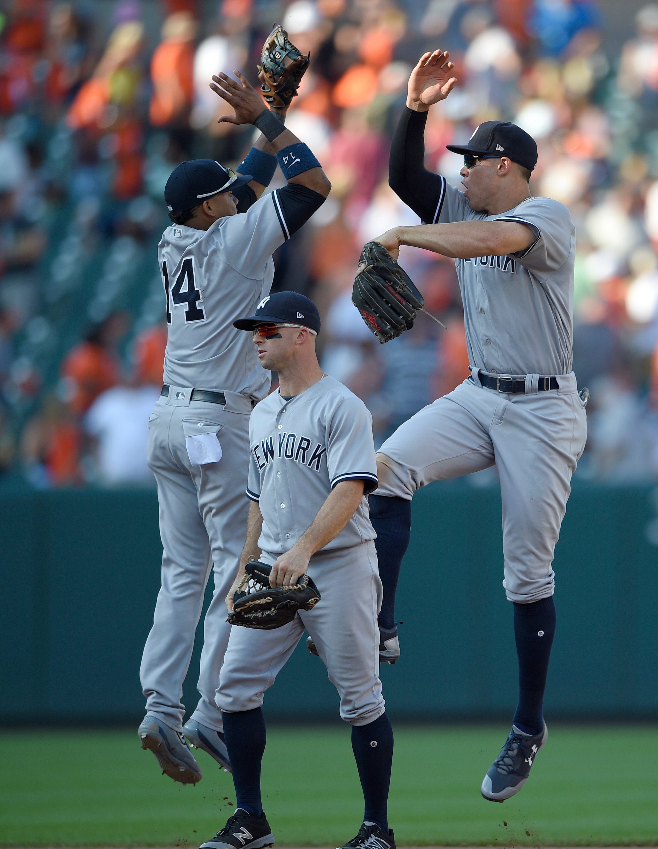 New York Yankees' Starlin Castro (14), Aaron Judge, right, and Brett Gardner, center, celebrate after a baseball game against the Baltimore Orioles, Monday, Sept. 4, 2017, in Baltimore. The Yankees won 7-4. (AP Photo/Nick Wass)