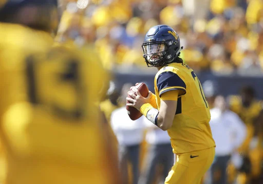 West Virginia quarterback Will Grier (7) looks for an open receiver during the second half of an NCAA college football game against East Carolina, Saturday, Sept. 9, 2017, in Morgantown, W.Va. West Virginia defeated East Carolina 56-20. (AP Photo/Raymond Thompson)