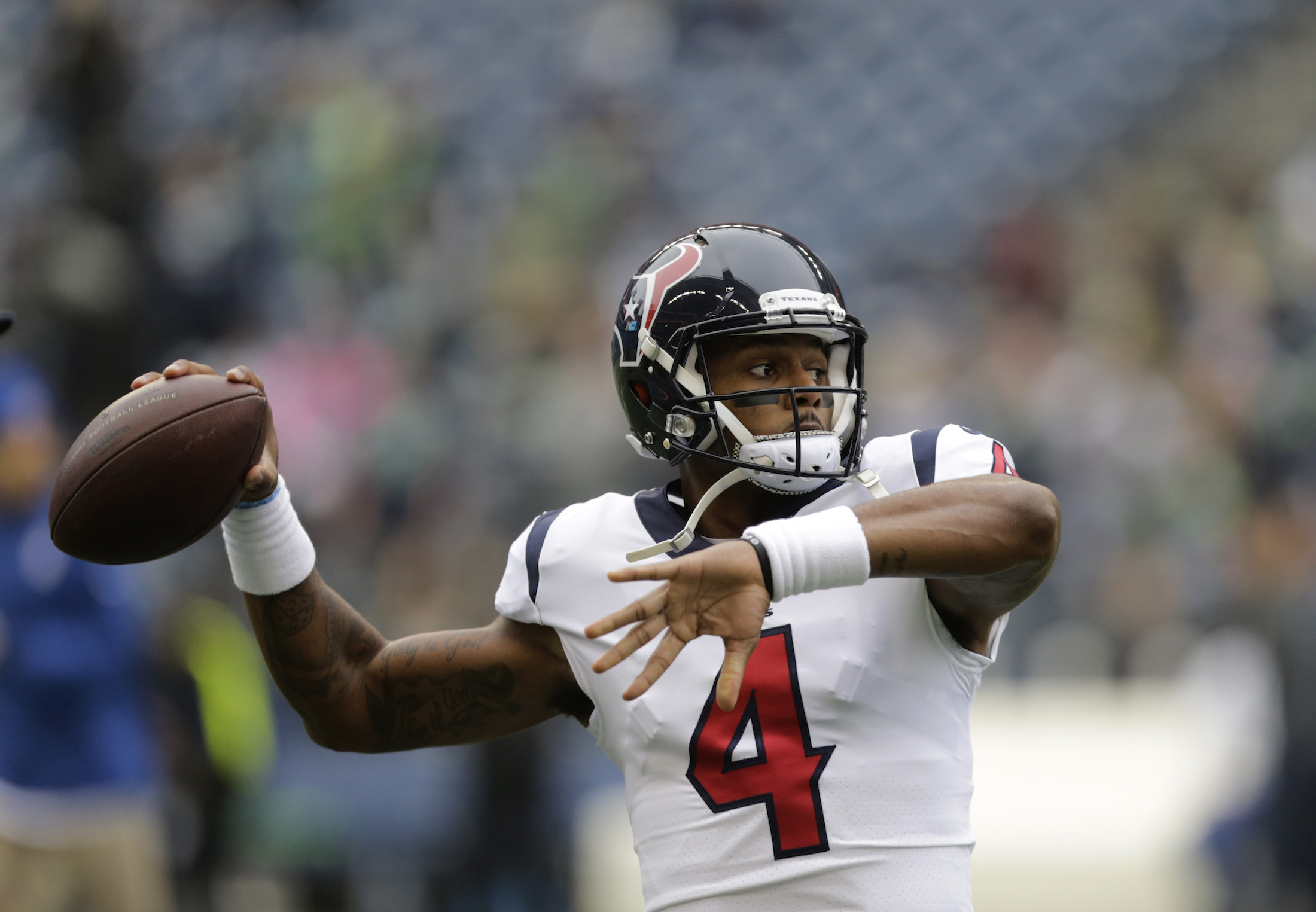 Houston Texans quarterback Deshaun Watson passes during warmups before an NFL football game against the Seattle Seahawks, Sunday, Oct. 29, 2017, in Seattle. (AP Photo/Stephen Brashear)