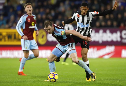 Burnley's Ashley Barnes, left, and Newcastle United's Isaac Hayden battle for the ball during the English Premier League soccer match Burnley versus Newcastle at Turf Moor, Burnley, England, Monday Oct. 30, 2017. (Martin Rickett/PA via AP)