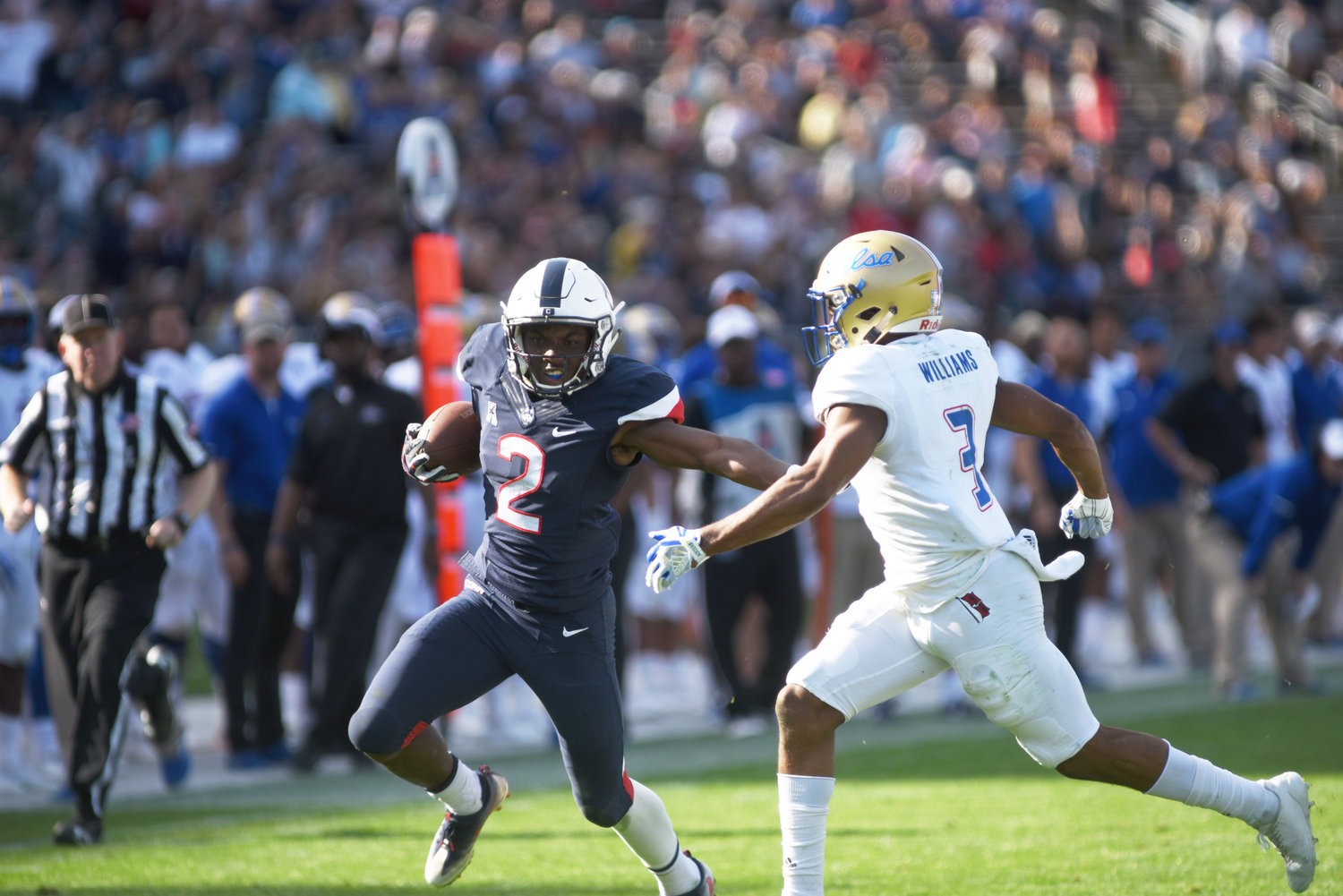UConn wide receiver Tyraiq Beals stiff arms a Tulsa defender during the Huskies' 20-14 over Tulsa Saturday at Rentschler Field in East Hartford. (Charlotte Lao, Associate Photo Editor/The Daily Campus)