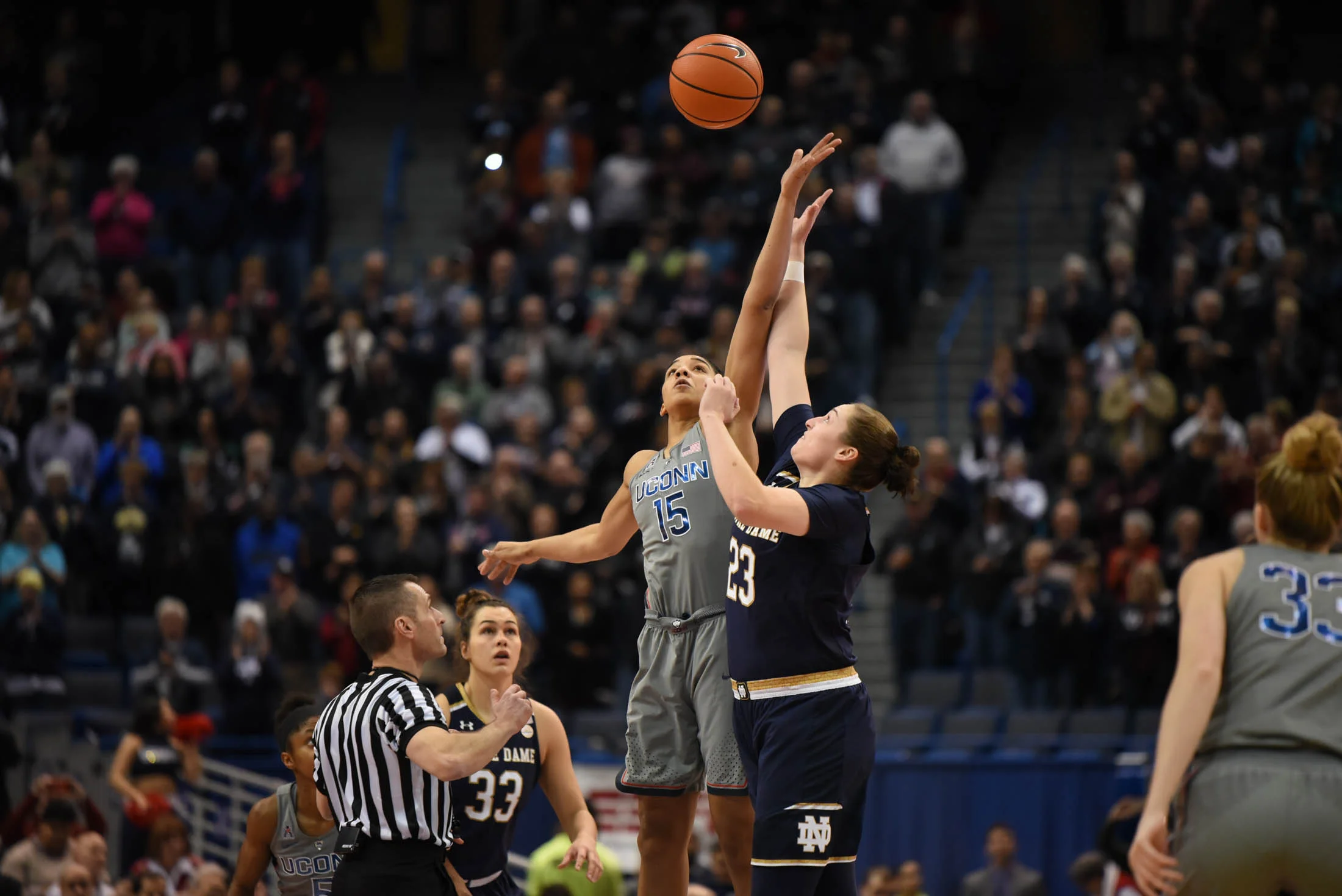 Gabby Williams jumps to win the tip off to start the game against Notre Dame. (Charlotte Lao/The Daily Campus)
