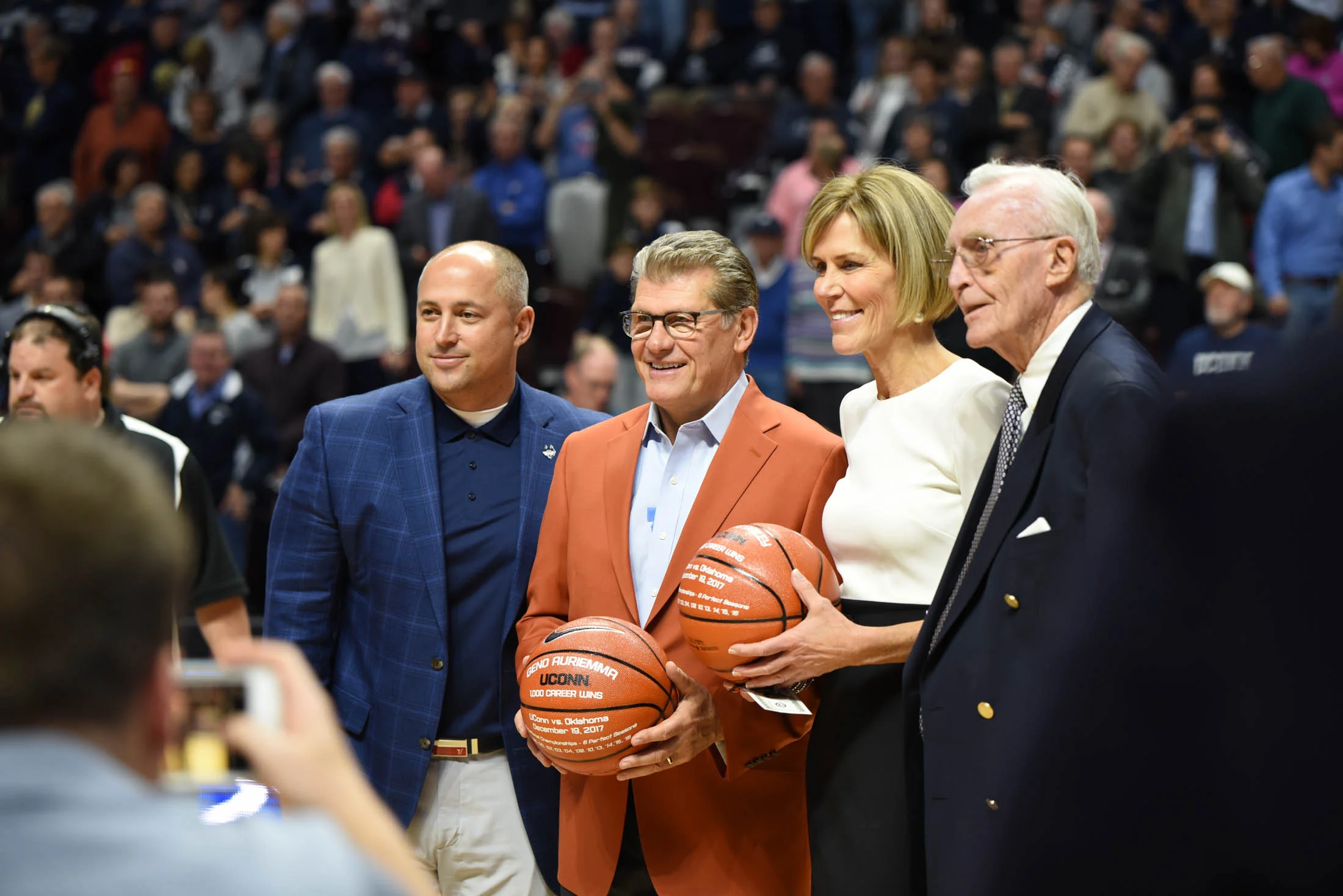 Geno Auriemma and Chris Dailey receive basketballs for their achievement. (Charlotte Lao/The Daily Campus) 
