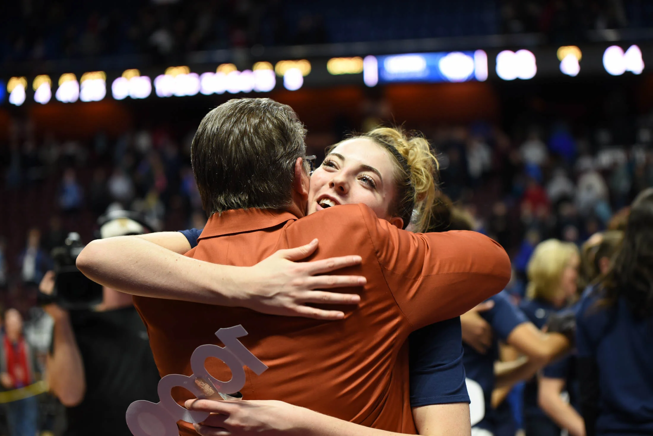 Katie Lou Samuelson congratulates her coach for his accomplishment. (Charlotte Lao/The Daily Campus) 