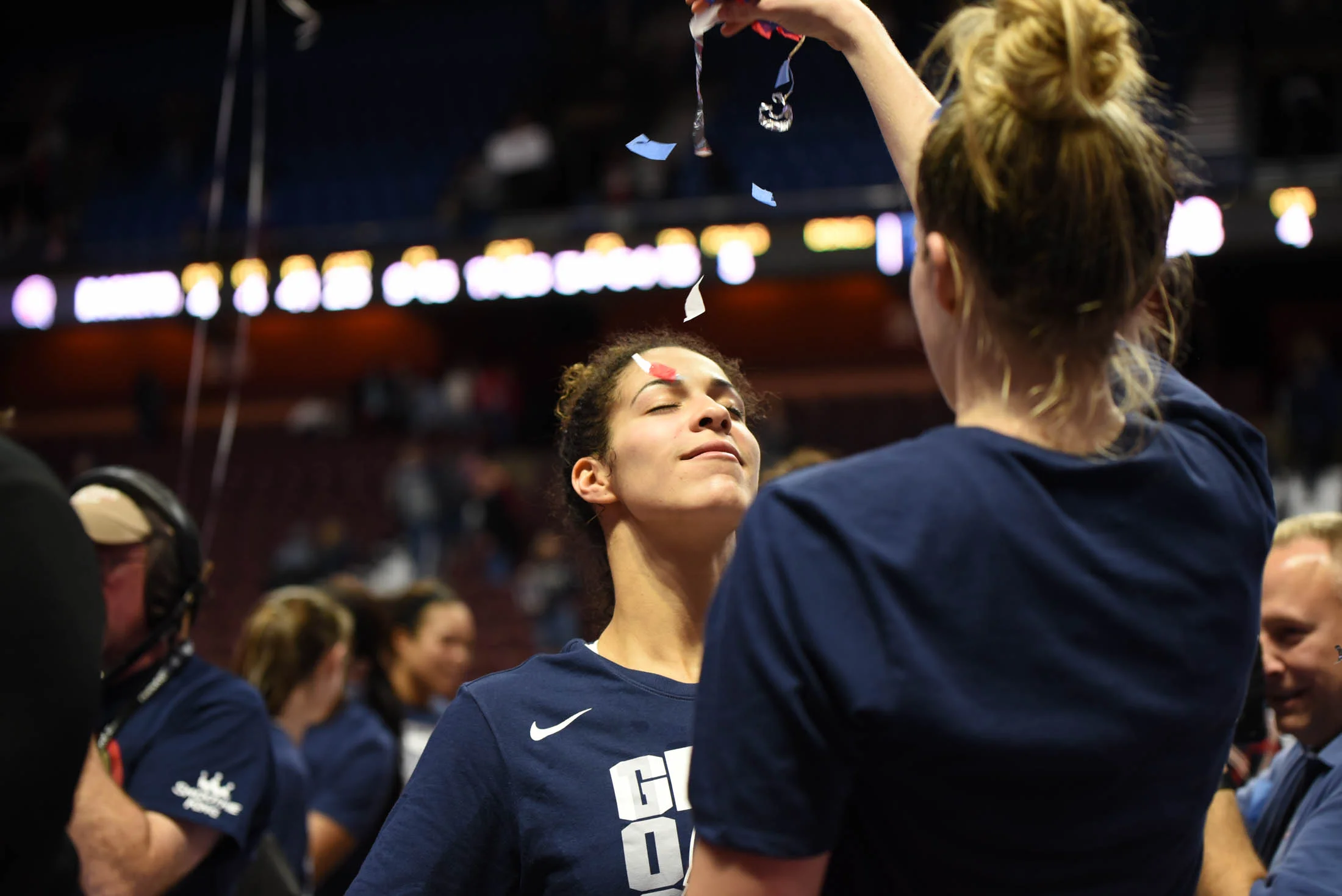 Kia Nurse celebrates the 1000 wins as Katie Lou Samuelson showers her with confetti. (Charlotte Lao/The Daily Campus) 