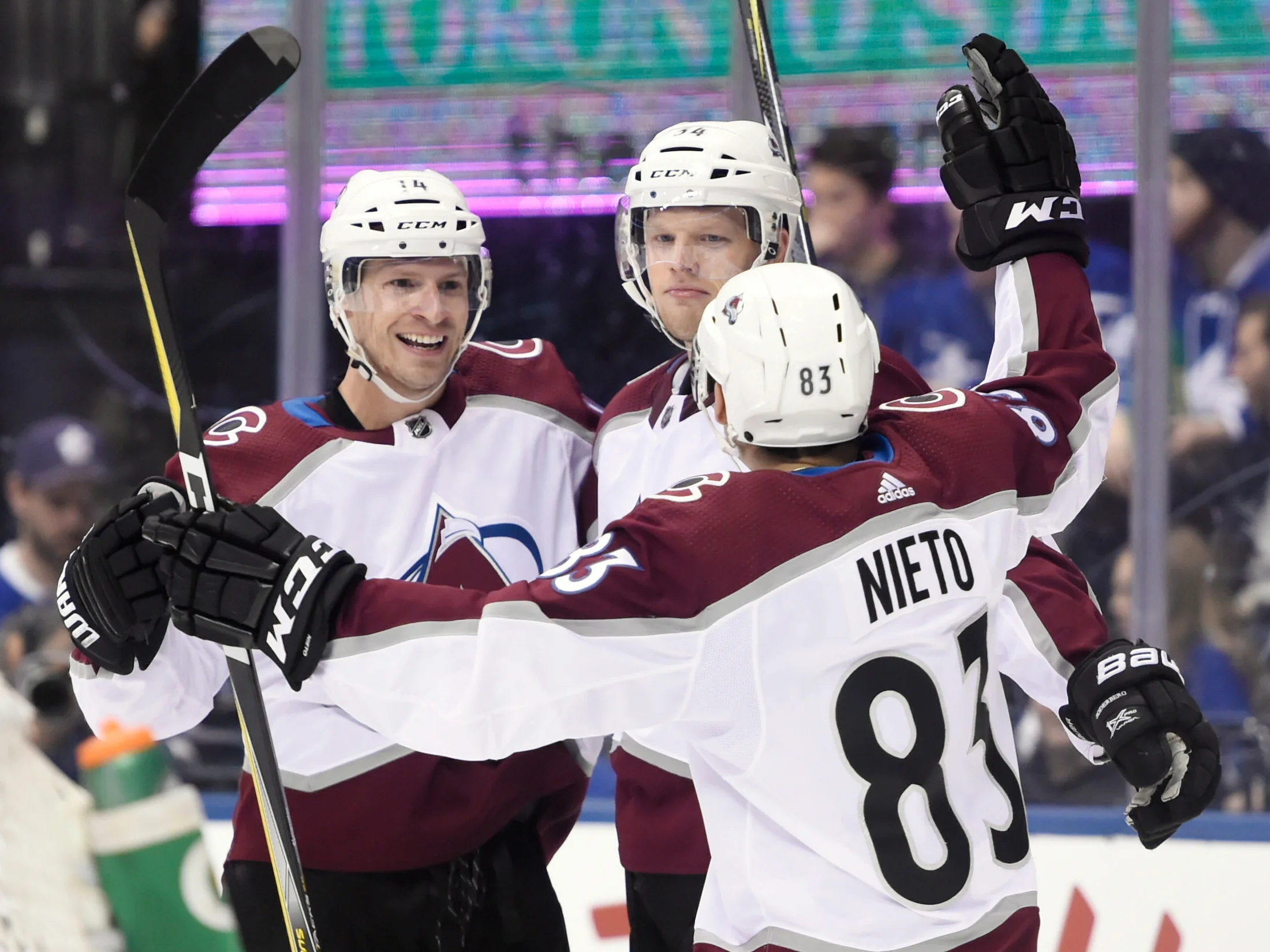 Colorado Avalanche left wing Blake Comeau (14) celebrates his goal with center Carl Soderberg (34) and left wing Matt Nieto (83) during third-period NHL hockey game action against the Toronto Maple Leafs in Toronto, Monday, Jan. 22, 2018. (Nathan Denette/The Canadian Press via AP)
