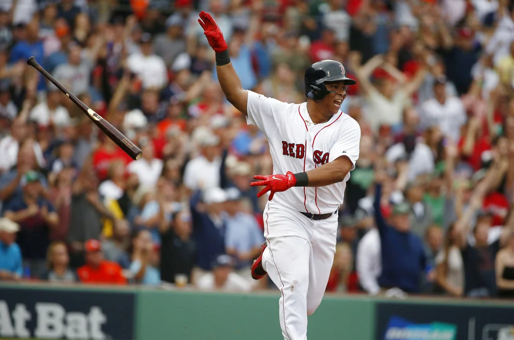 In this Oct. 8, 2017, file photo, Boston Red Sox's Rafael Devers tosses his bat after hitting a two-run home run against the Houston Astros during the third inning in Game 3 of baseball's American League Division Series, in Boston. (AP Photo/Michael Dwyer, File)