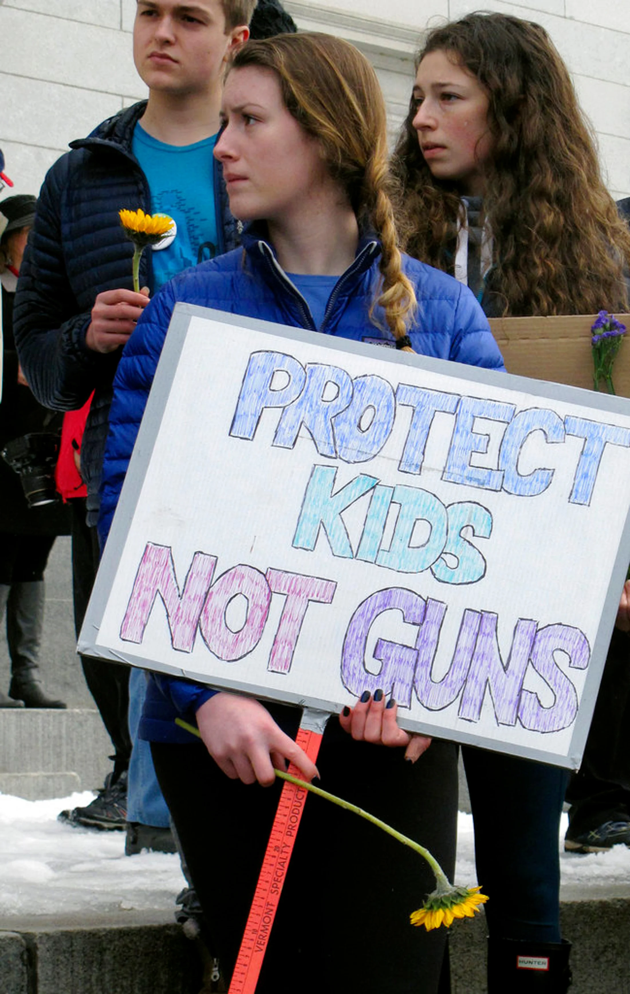 Alex Devaux, of Richmond, Vt., holds a sign outside the Vermont Statehouse in Montpelier, Vt., on Tuesday Feb. 20, 2018. Devaux, a high school senior, attended the demonstration that followed comments by Republican Gov. Phil Scott who said he was open to discussion about gun control as part of a broader discussion of ways to reduce violence. Scott's comments came after Vermont police arrested a suspect who they say was preparing for a school shooting. Vermont has long been considered to have some of the most lax gun control laws in the country. (AP Photo/Wilson Ring)