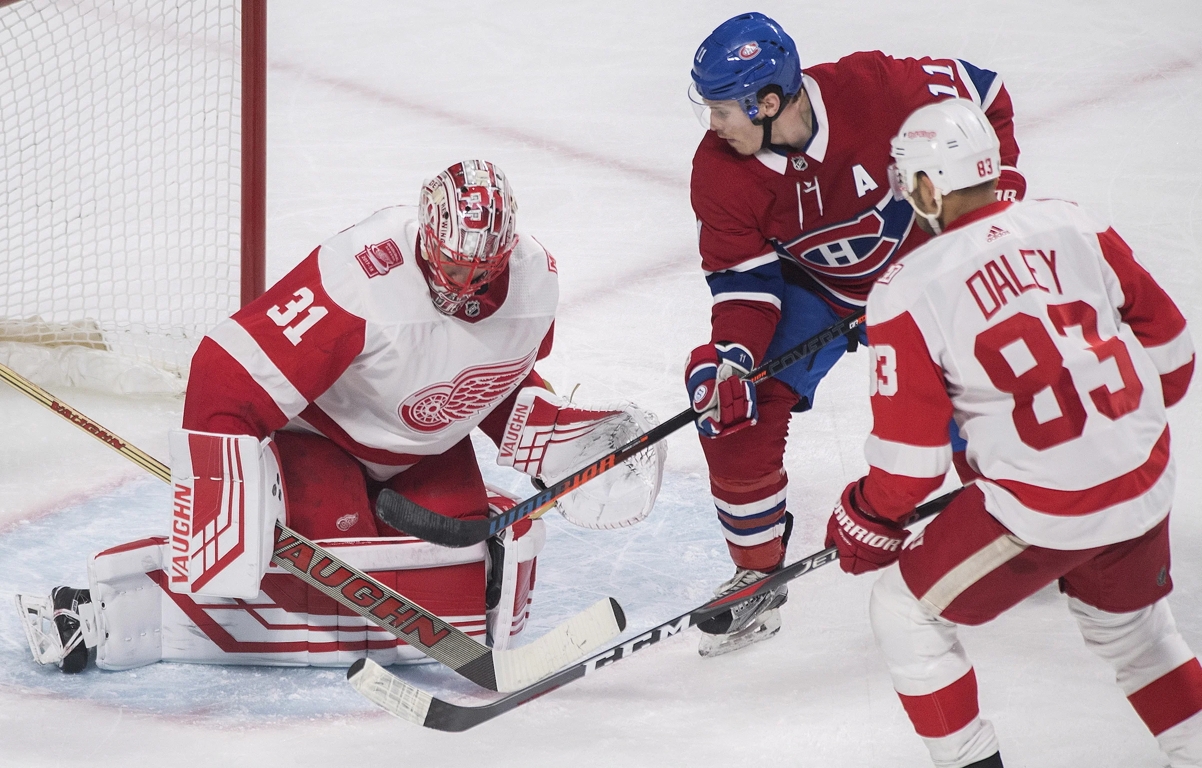 Montreal Canadiens right wing Brendan Gallagher (11) moves in against Detroit Red Wings goaltender Jared Coreau (31) as defenseman Trevor Daley (83) defends during third-period NHL hockey game action in Montreal, Monday, March 26, 2018. (Graham Hughes/The Canadian Press via AP)