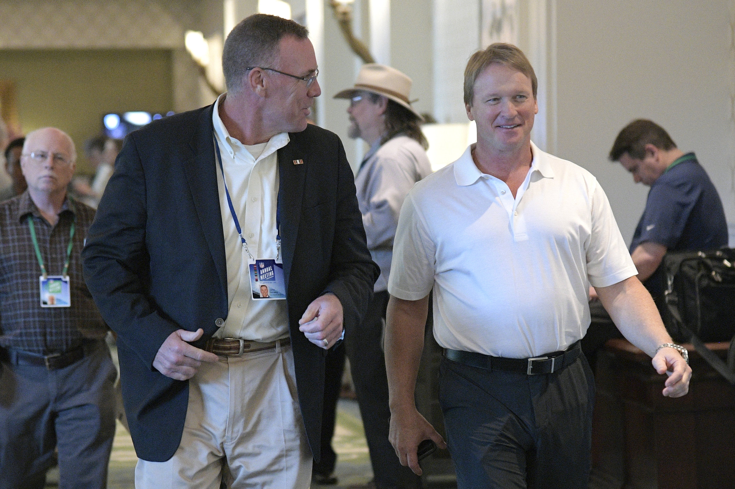 Cleveland Browns general manager John Dorsey, left, and Oakland Raiders head coach Jon Gruden chat during the NFL owners meetings, Monday, March 26, 2018 in Orlando, Fla. (Phelan M. Ebenhack/AP Images for NFL)