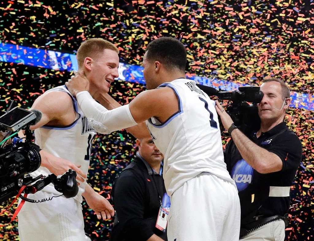 Villanova's Donte DiVincenzo, left, and Jalen Brunson celebrate after the championship game of the Final Four NCAA college basketball tournament against Michigan, Monday, April 2, 2018, in San Antonio. Villanova won 79-62. (AP Photo/David J. Phillip)