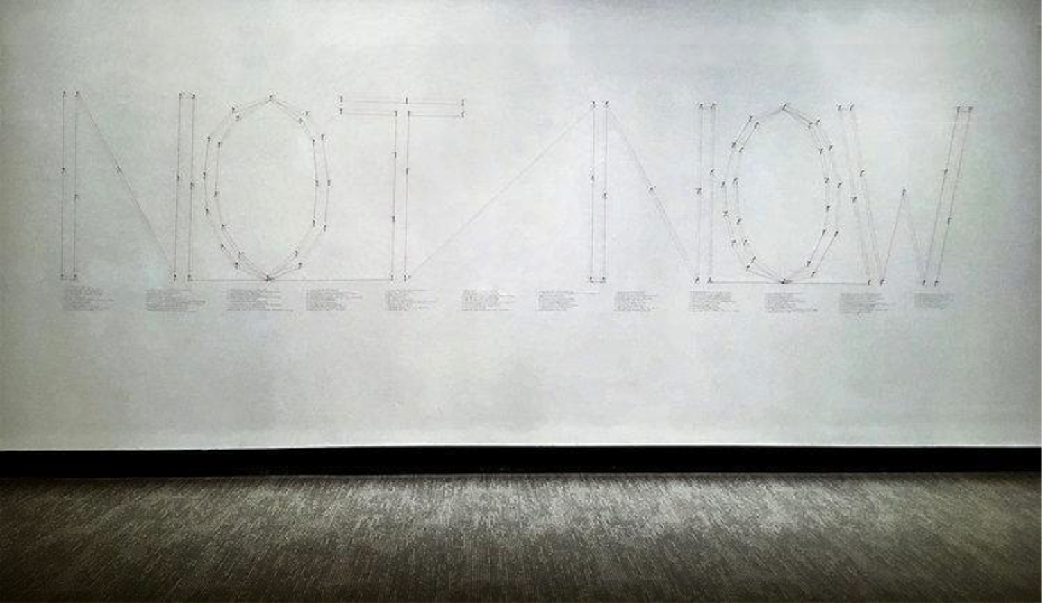 Another piece by Kelsey Miller titled "105 Days Before Today" (March 27, 2017). Installation using nails, thread, and handwritten daily headlines from common news sources in the US. (Photo courtesy of kelseynmiller.com )