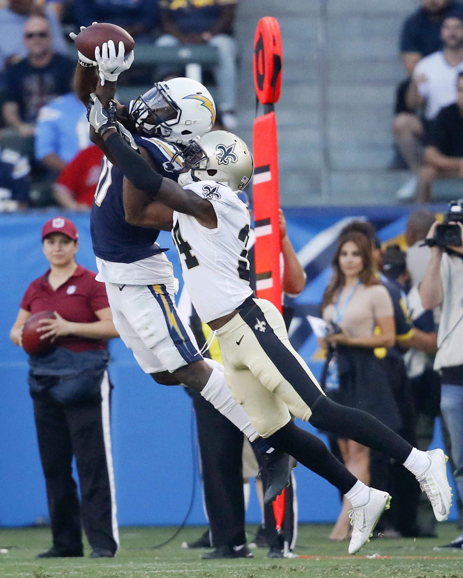 Los Angeles Chargers wide receiver Geremy Davis, hauls in a pass as Saints defensive back Vonn Bell covers during the second half of an NFL preseason football game. (AP Photo/Jae C. Hong)
