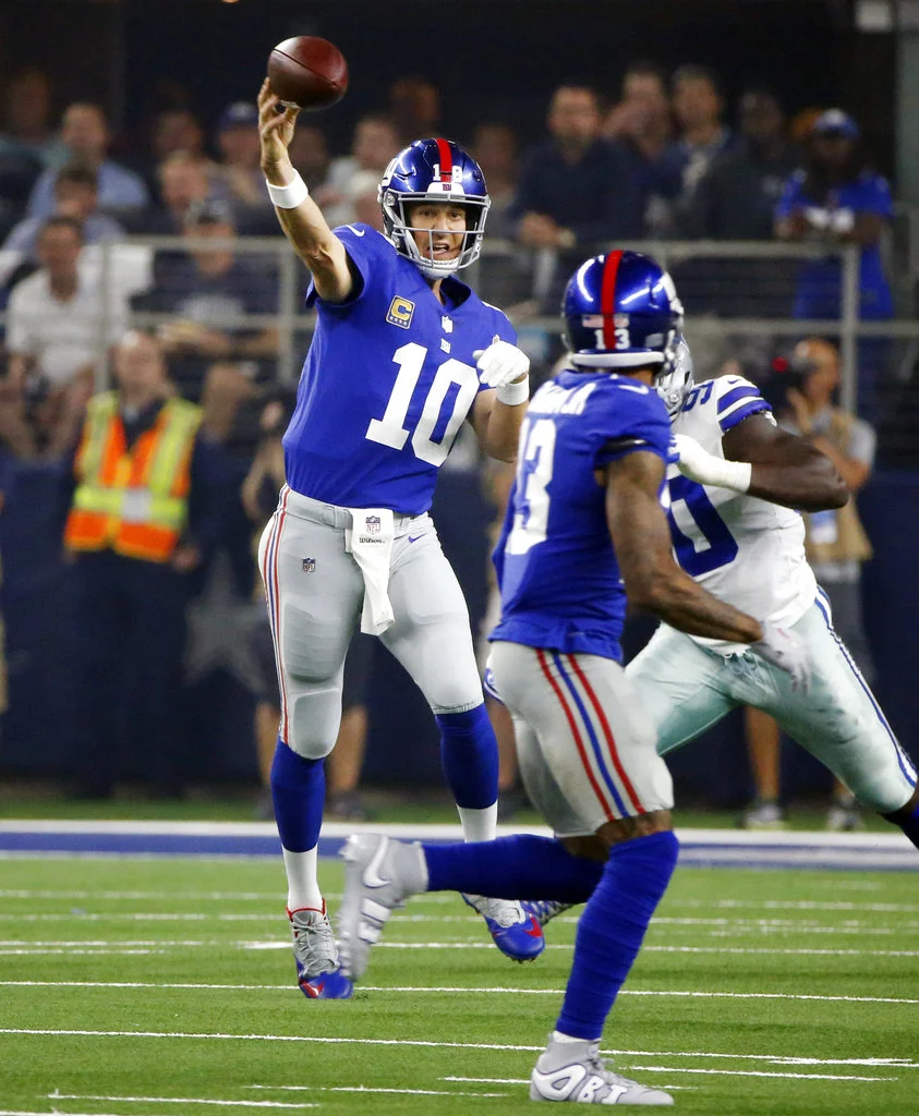 New York Giants quarterback Eli Manning (10) throws against the Dallas Cowboys during the first half of an NFL football game in Arlington, Texas, Sunday, Sept. 16, 2018. (AP Photo/Michael Ainsworth)