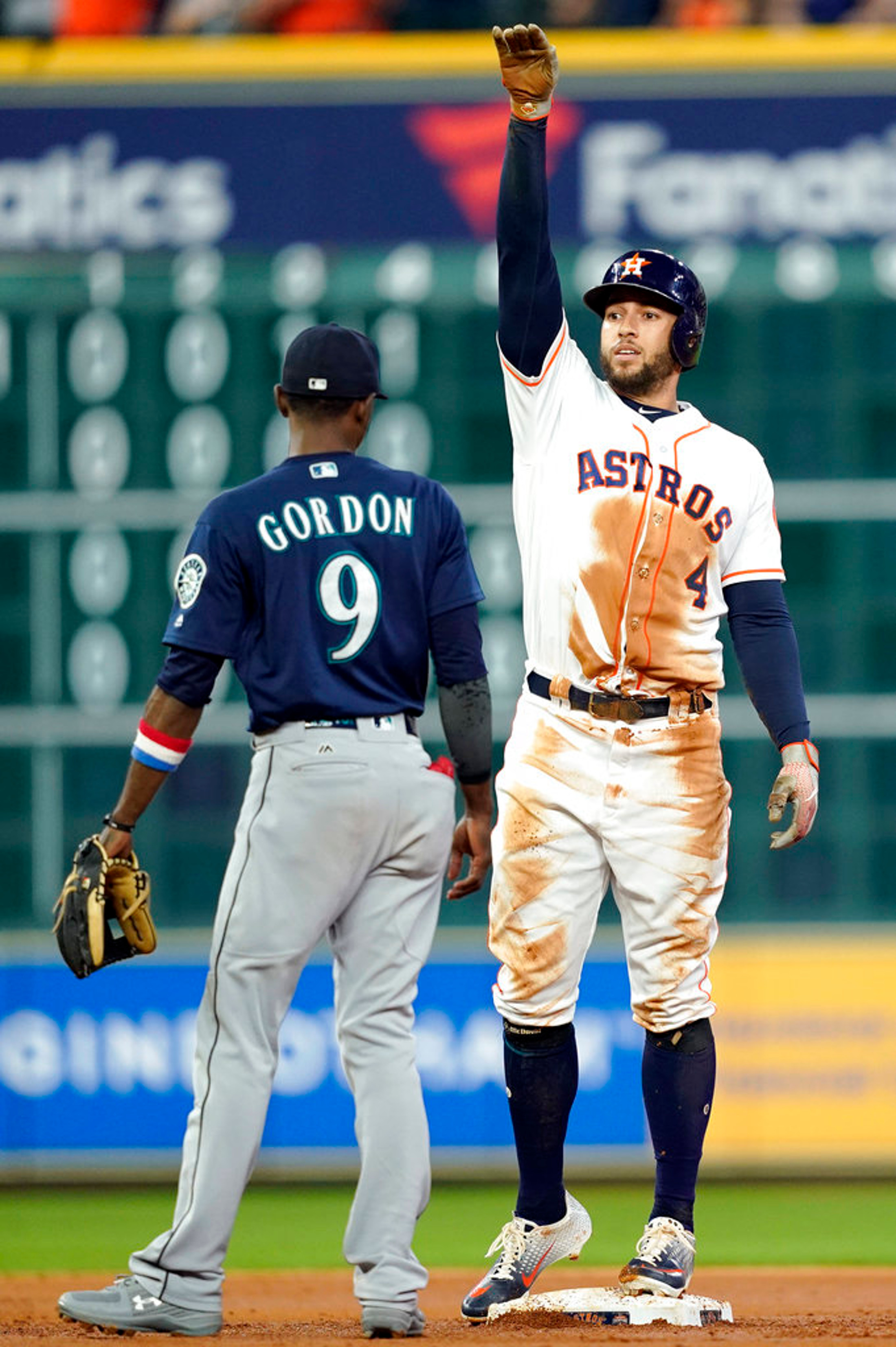 Houston Astros' George Springer (4) celebrates after a RBI single as Seattle Mariners second baseman Dee Gordon (9) watches during the third inning of a baseball game Tuesday, Sept. 18, 2018, in Houston. (AP Photo/David J. Phillip)