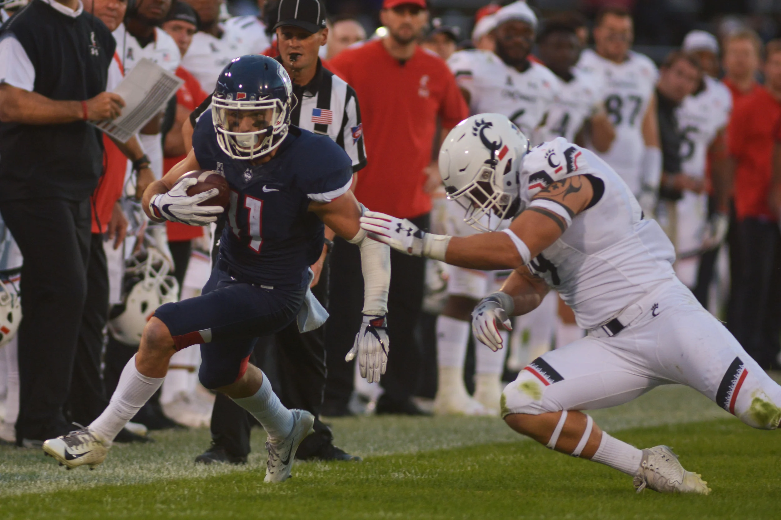 Kyle Buss avoids a Cincinnati opponent during a game on Saturday, Sept. 29 at Rentschler Field. (Nicholas Hampton, Associate Photo Editor/The Daily Campus)