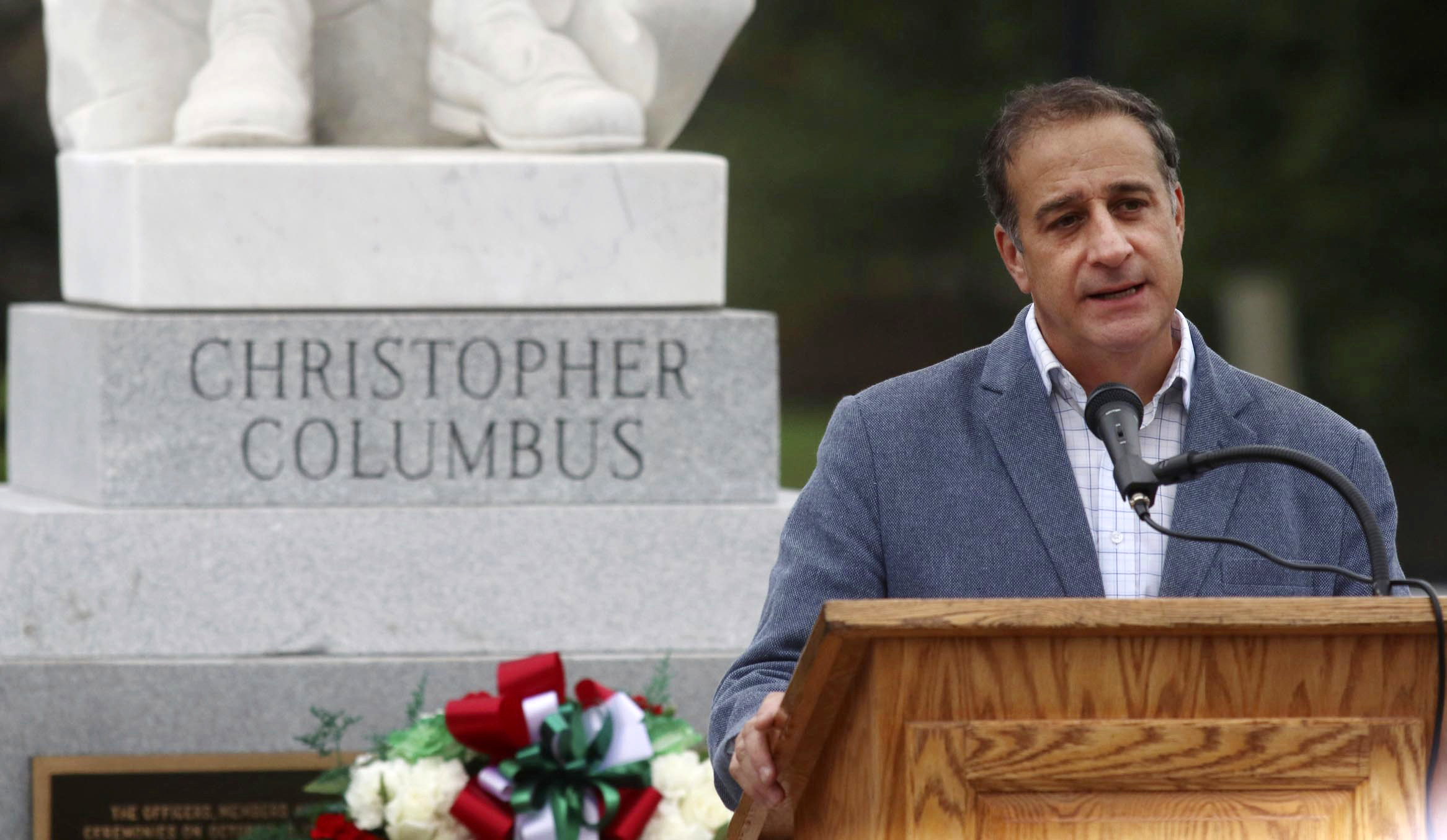 Pittston, Pa., Mayor Michael Lombardo addresses the gathering on Main Street in front of the town's Christopher Columbus statue during a program celebrating Columbus as well as the area's Italian heritage on Sunday, Oct. 7 in Pittston. (Dave Scherbenco/The Citizens' Voice via AP)
