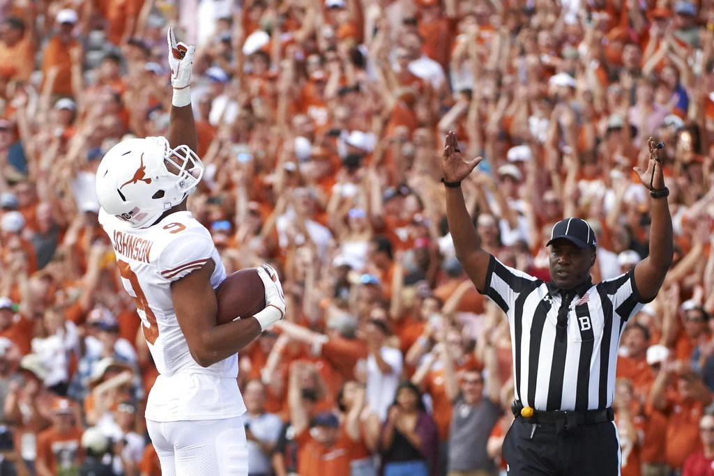FILE- In this Saturday, Oct. 6, 2018, file photo, Texas wide receiver Collin Johnson (9) celebrates after scoring a touchdown on a 2-yard reception during the first half of an NCAA college football game against Oklahoma at the Cotton Bowl in Dallas. Johnson and Lil’Jordan Humphrey have been a big problem for opposing defenses. The duo has combined for 65 catches and eight touchdowns for the No. 9 Longhorns. (AP Photo/Cooper Neill, File)