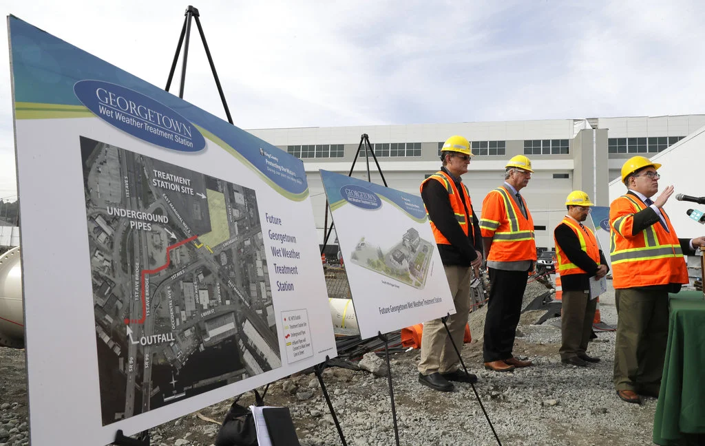 Andrew Wheeler, right, the U.S. Environmental Protection Agency's Acting Administrator, talks to reporters, Wednesday, Oct. 3, 2018, after touring the Georgetown Wet Weather Treatment Station in Seattle, a project funded by a low-interest loan from the EPA. The facility will treat millions of gallons of polluted stormwater that currently flows into Duwamish River during severe rainstorms. (AP Photo/Ted S. Warren)